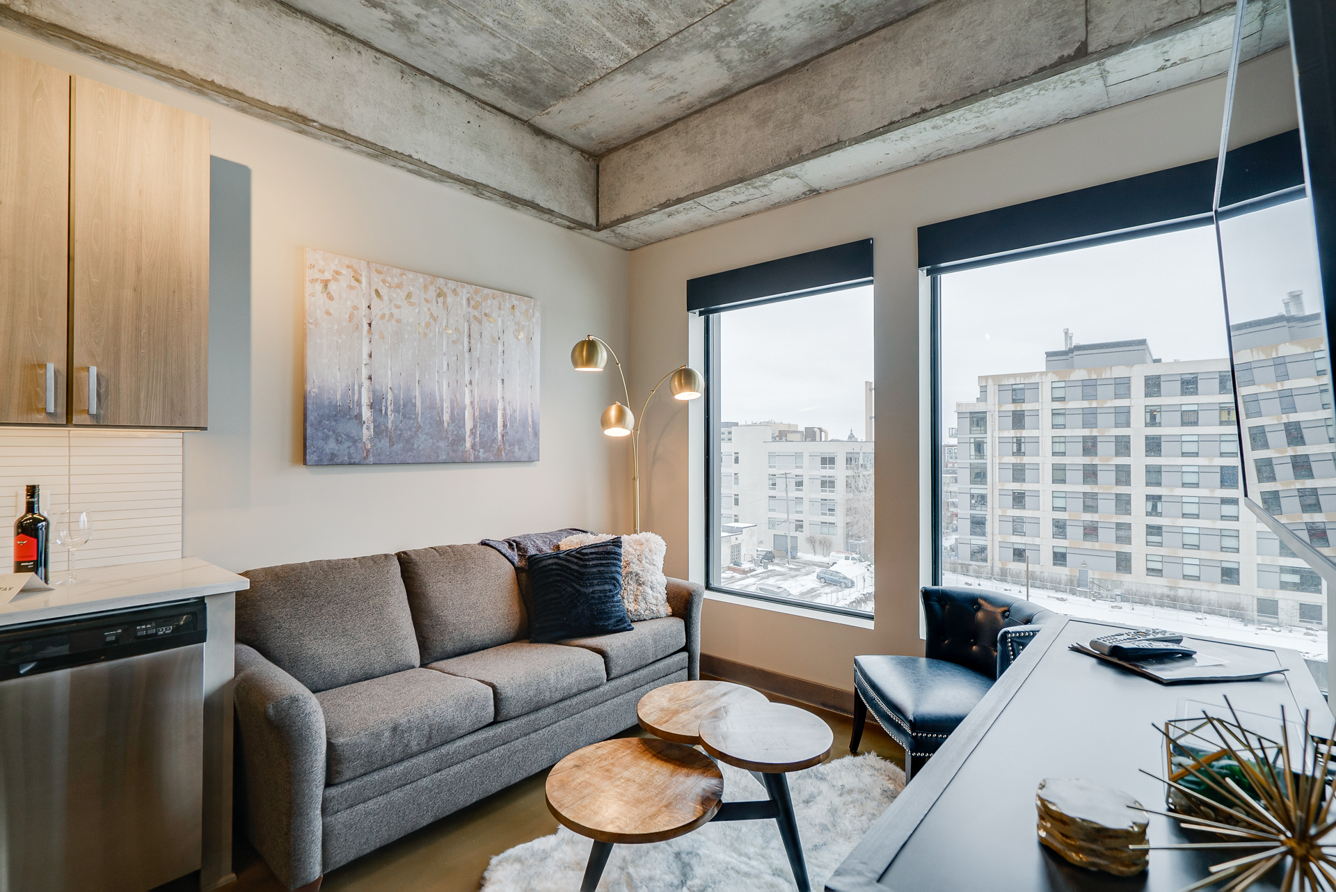 A stylish modern living room with large windows and minimalist decor.