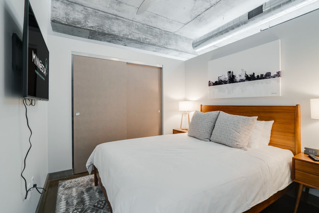 A modern bedroom featuring a minimalist design with a sleek bed and contemporary decor.