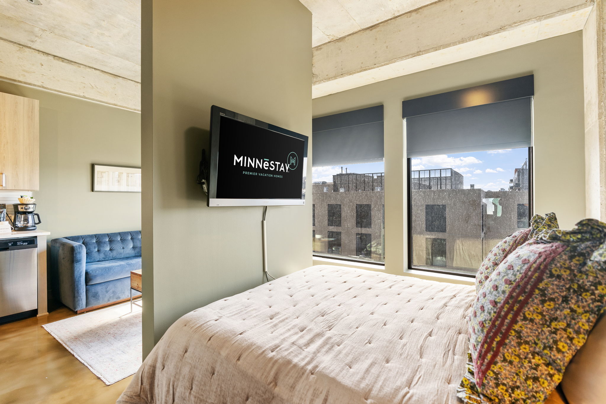 Chic studio apartment featuring a cozy bed and modern amenities.