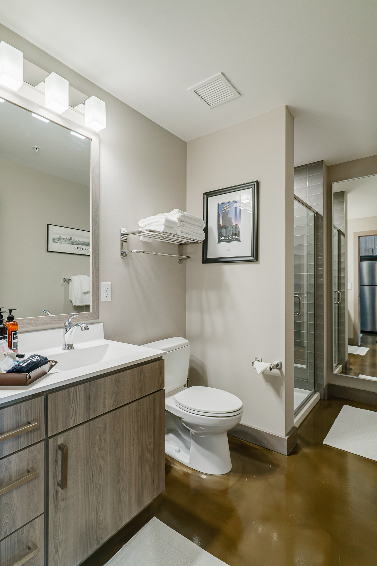 A modern bathroom featuring sleek designs and warm tones.
