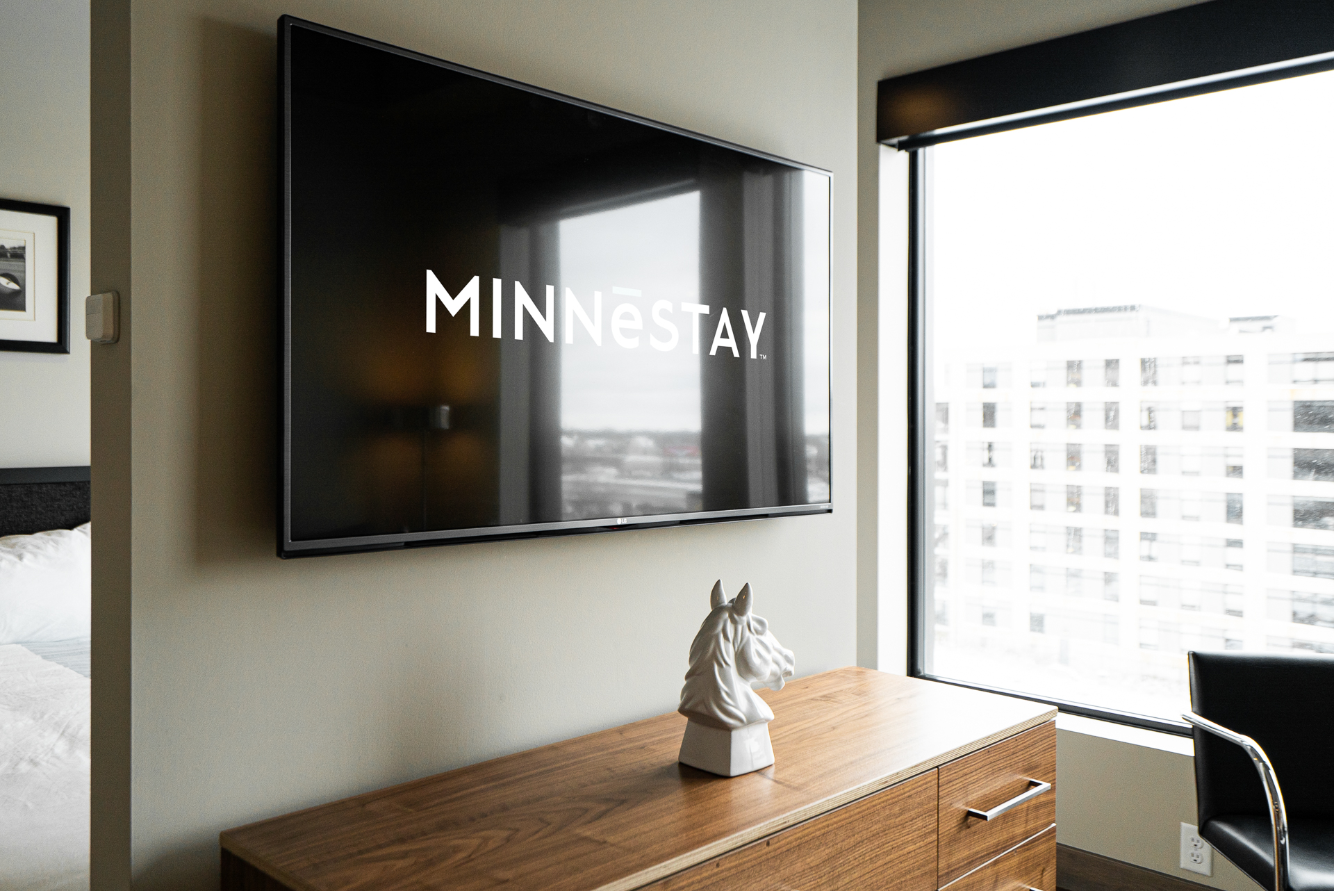 Modern hotel room featuring a sleek TV display and artistic decor.