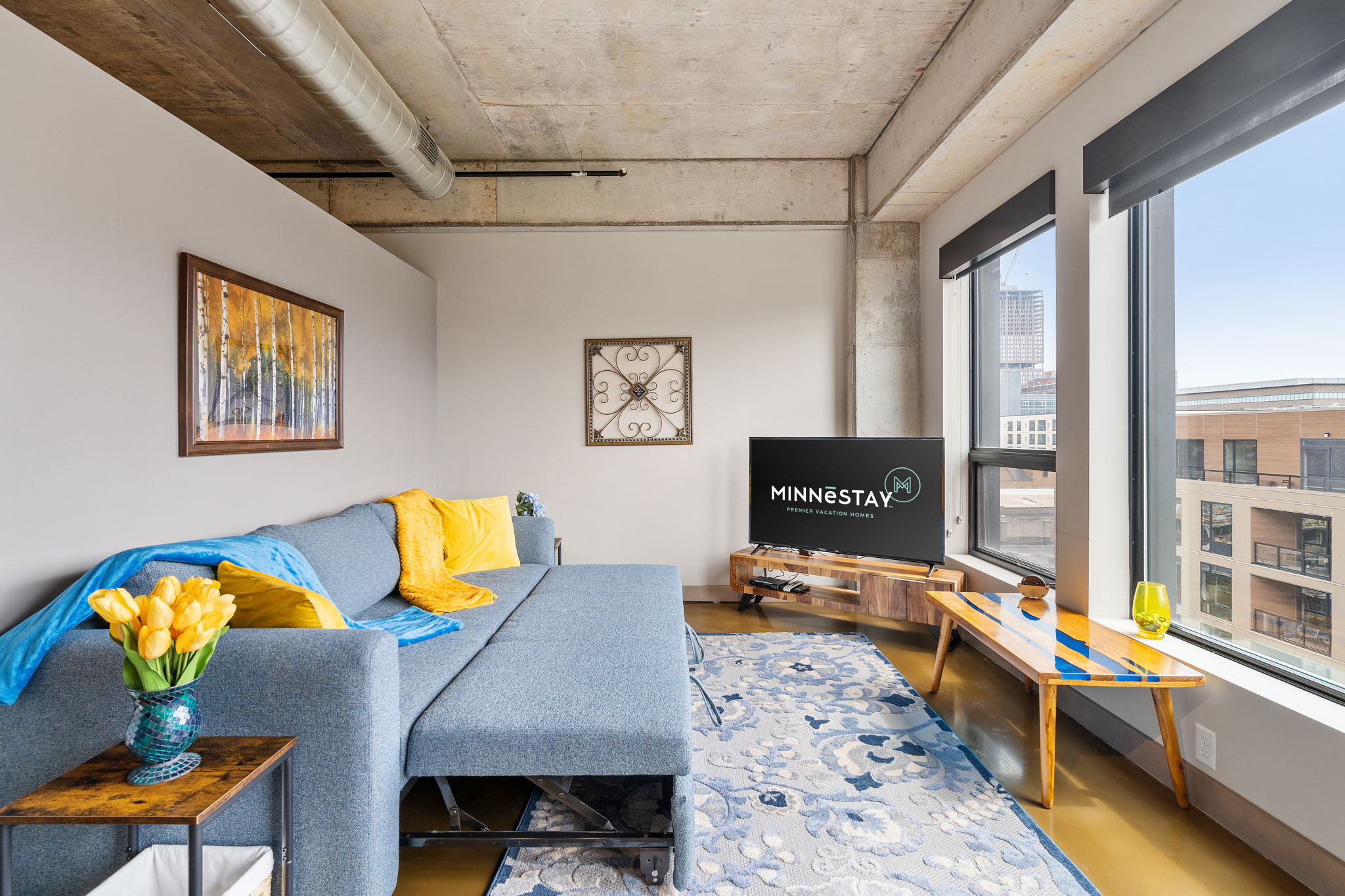 A stylish and inviting living room decorated with modern art and colorful accents.