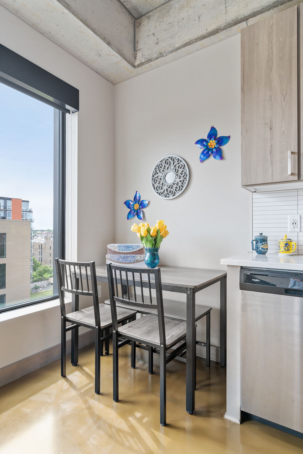 Charming modern dining nook with vibrant decor and city views.