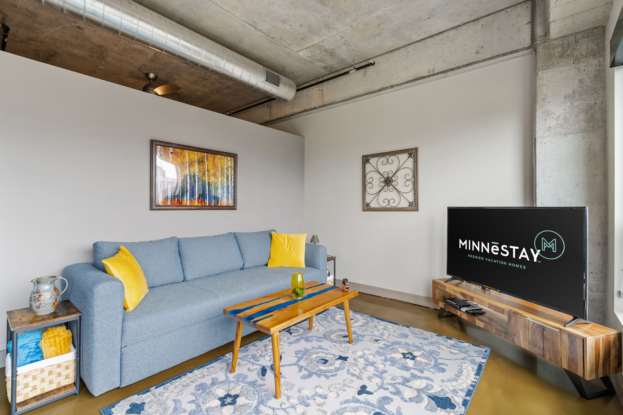 A stylish modern living room with blue and yellow accents.