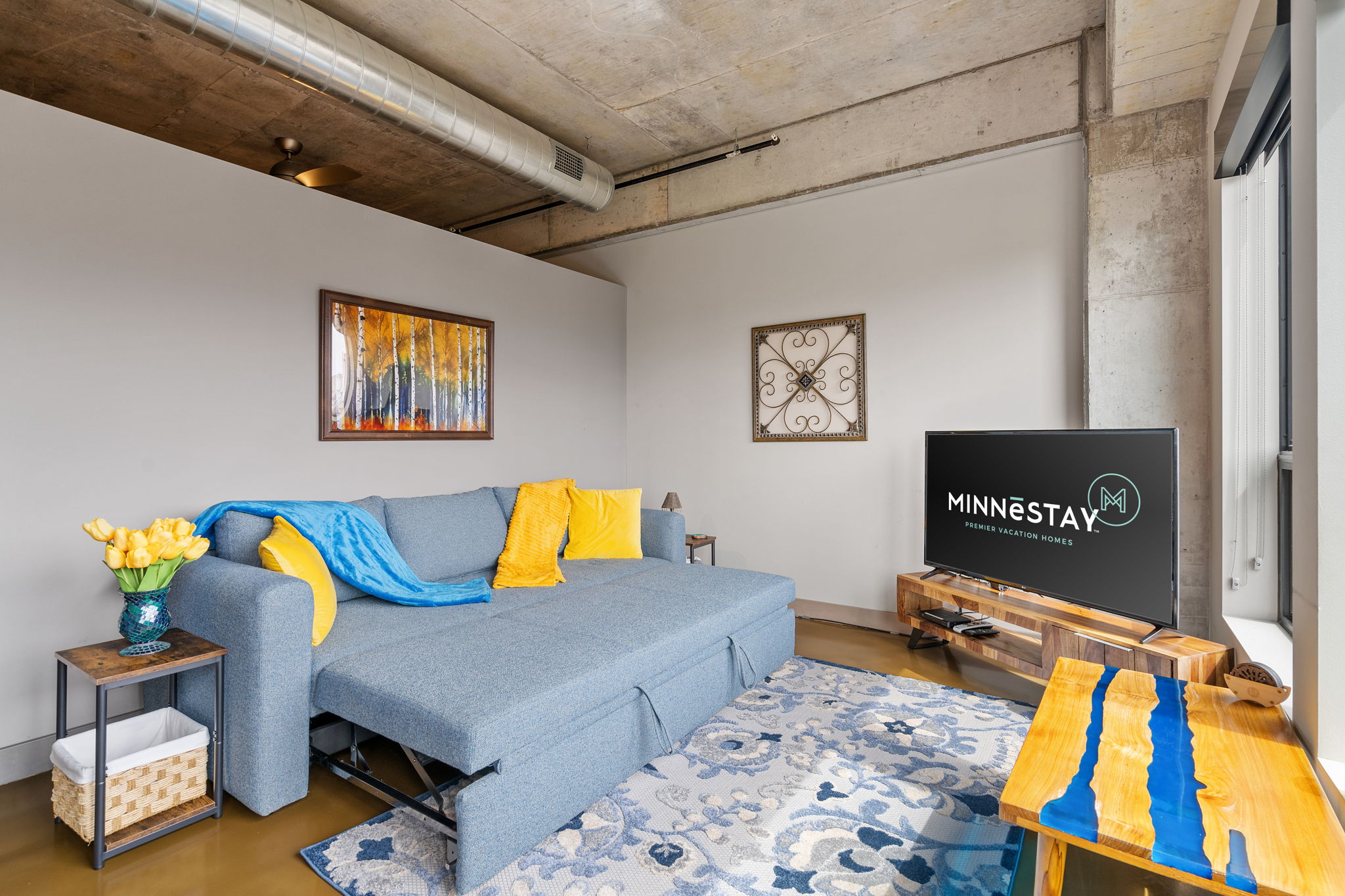 Chic urban living room with modern decor and vibrant accents.