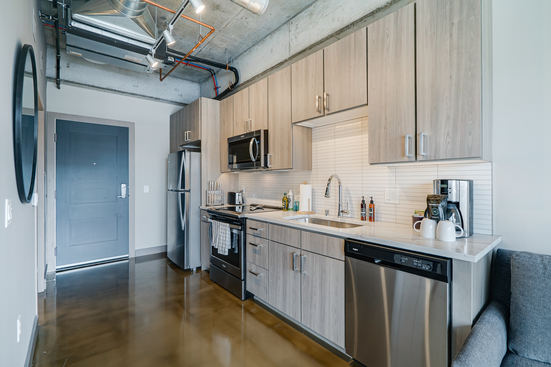 A modern kitchen design showcasing sleek cabinetry and contemporary appliances.