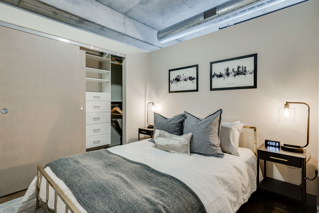 A stylish modern bedroom with minimalistic decor and an industrial touch.
