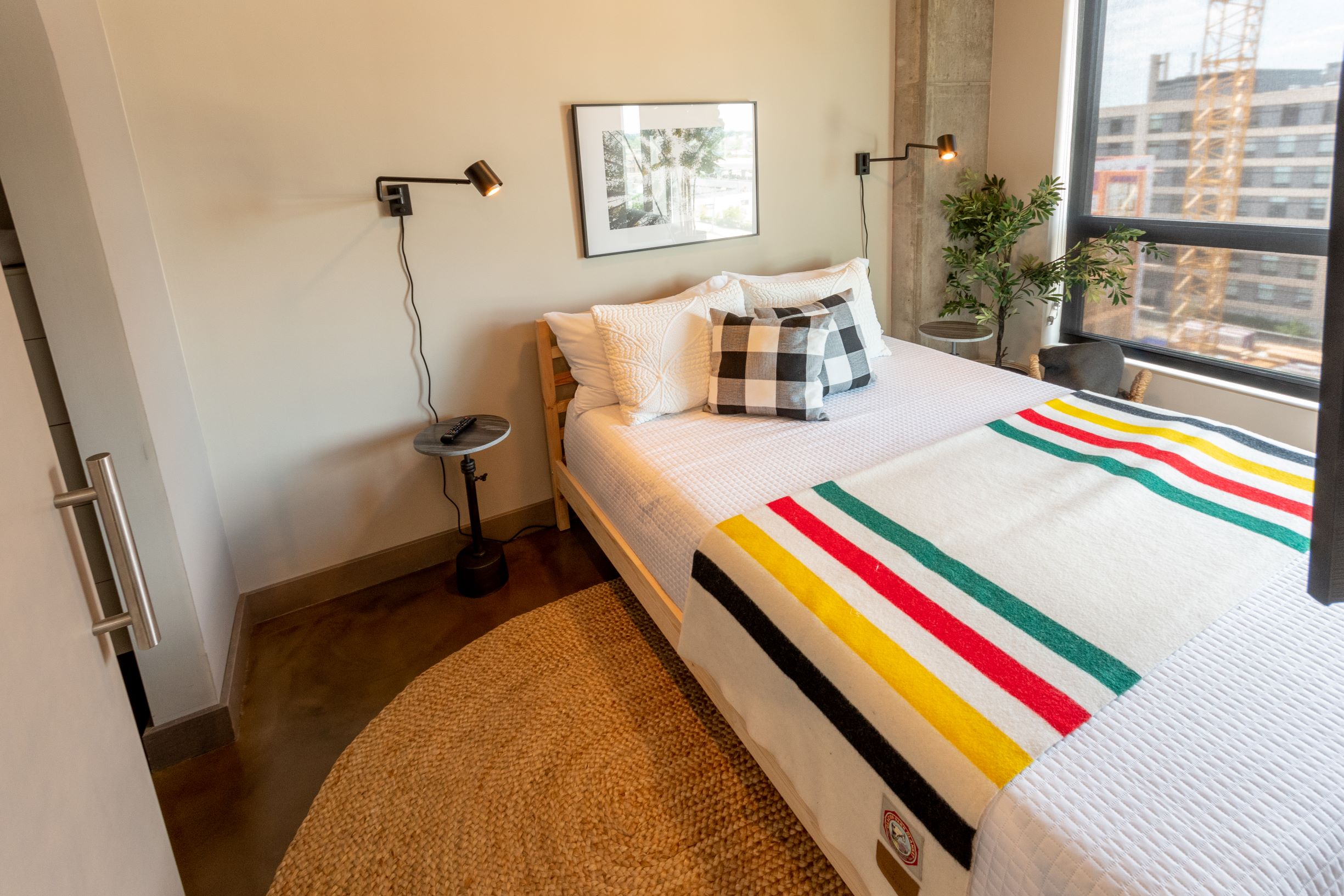 A modern and cozy bedroom with colorful accents and natural light.