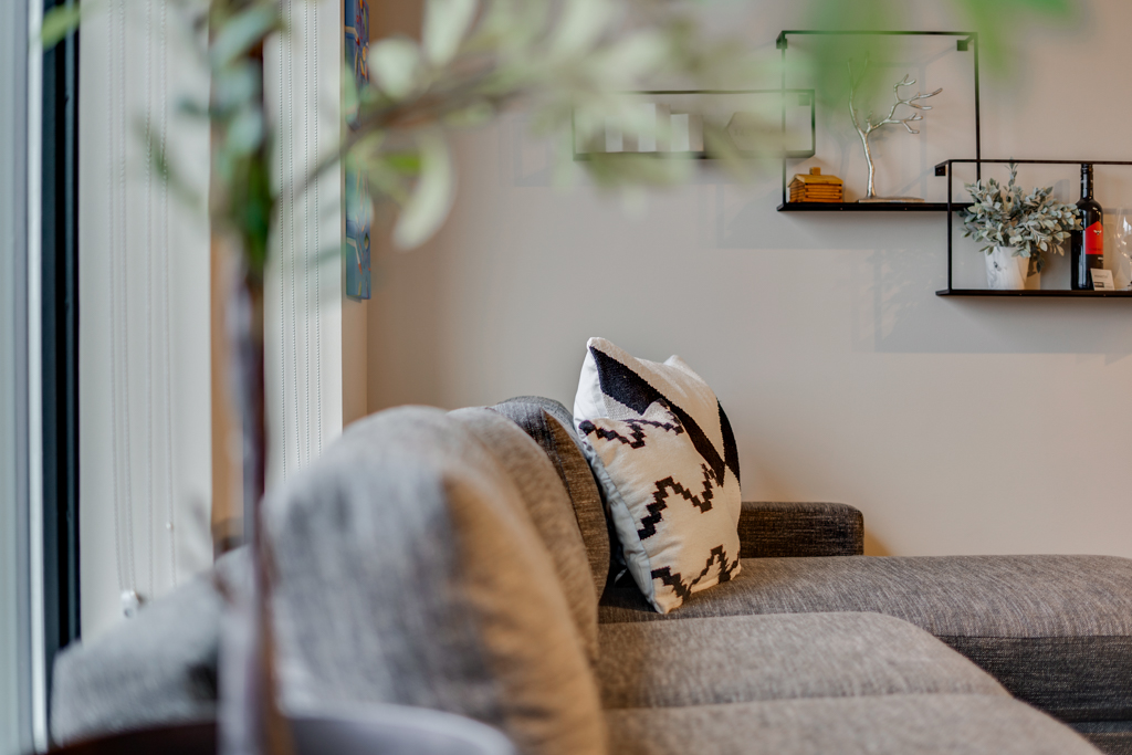 A stylish living room with a gray sectional couch and decorative touches.