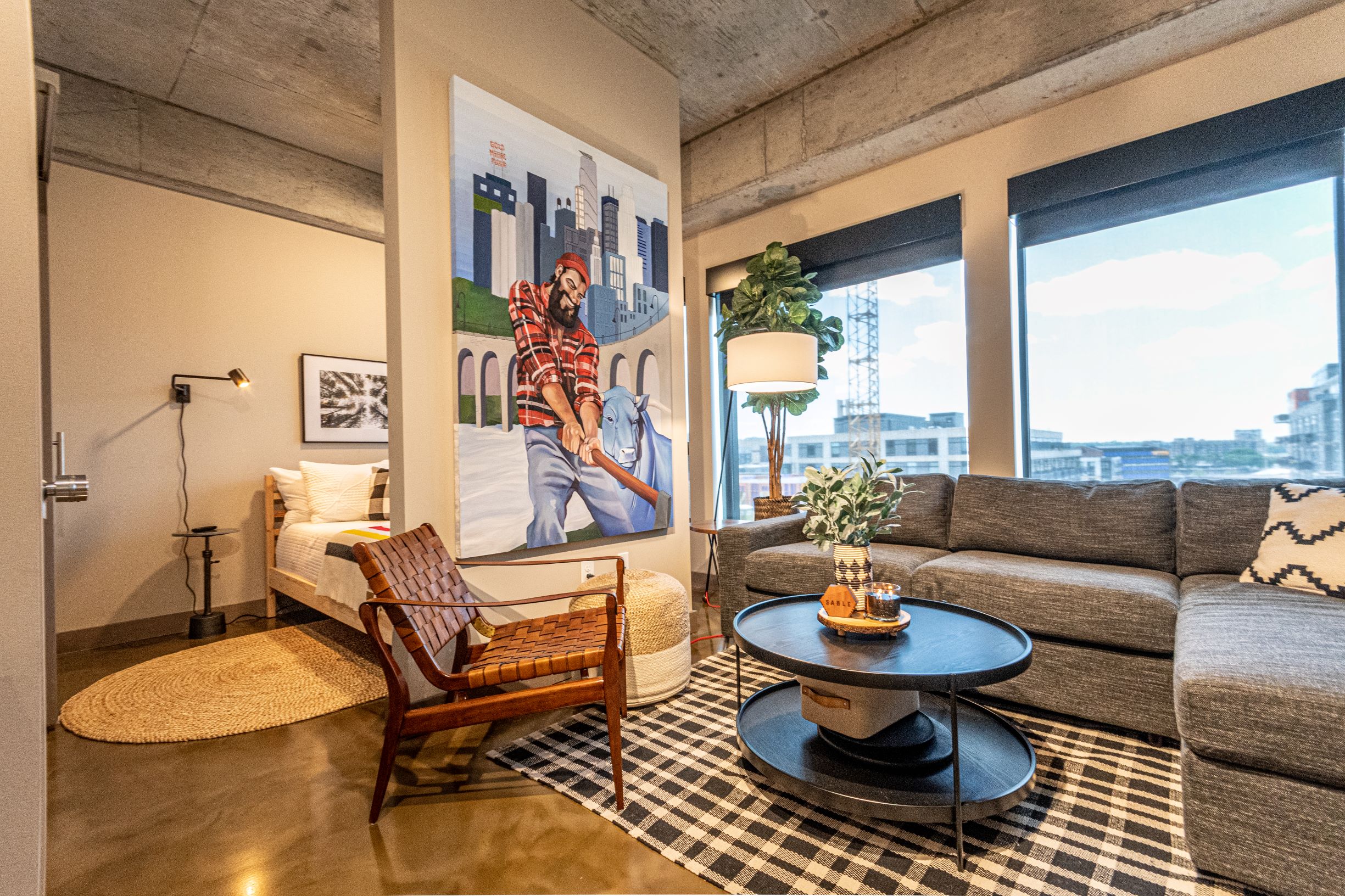 A modern living space with artistic decor and vibrant city views.