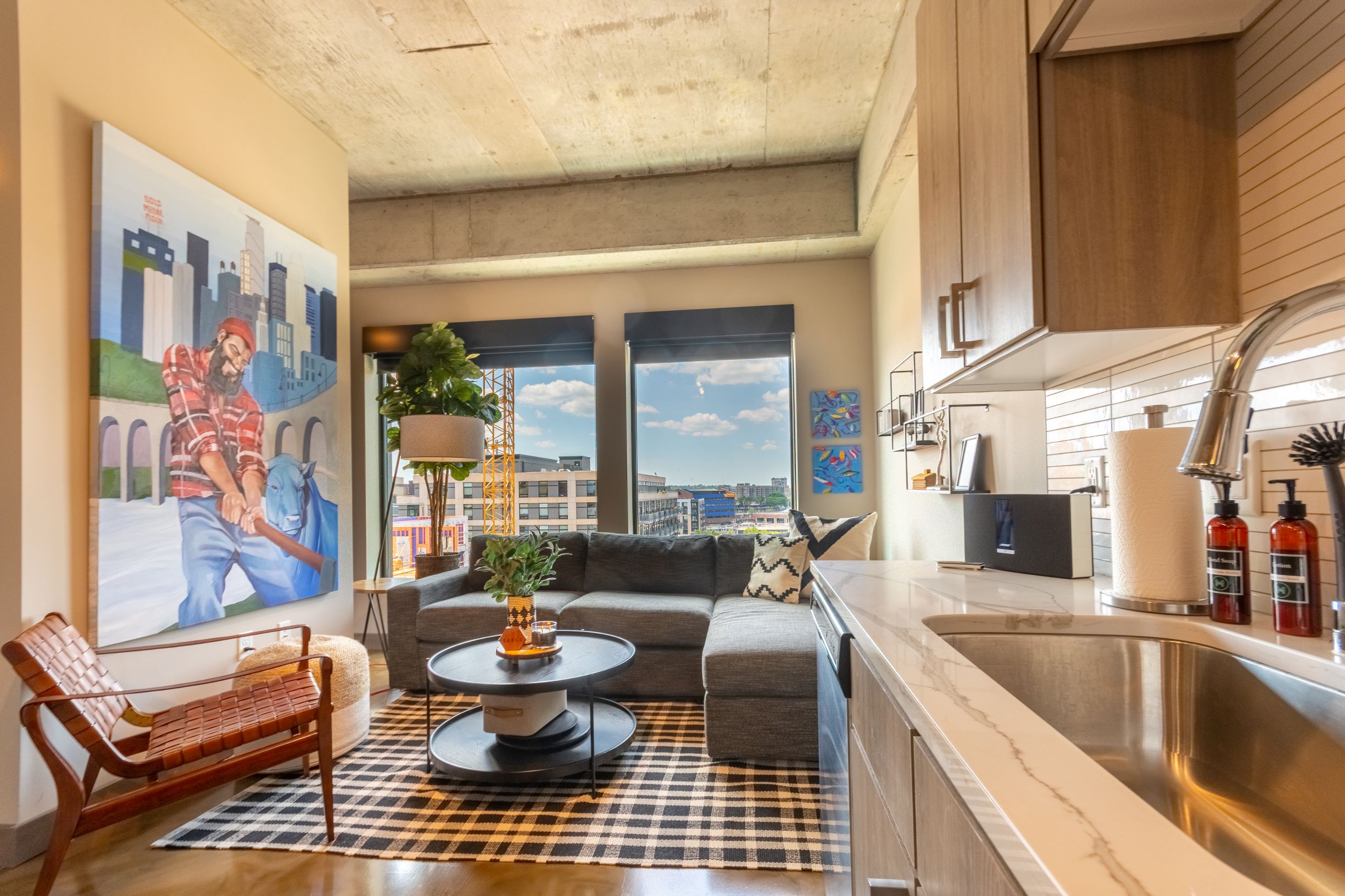 Modern apartment interior with urban artwork and sleek furnishings.