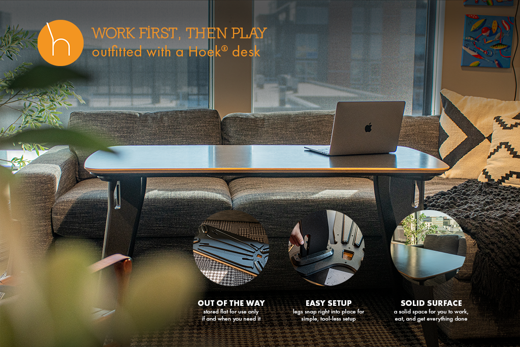 A modern workspace featuring a Hoek desk and a cozy couch, showcasing a blend of comfort and productivity.