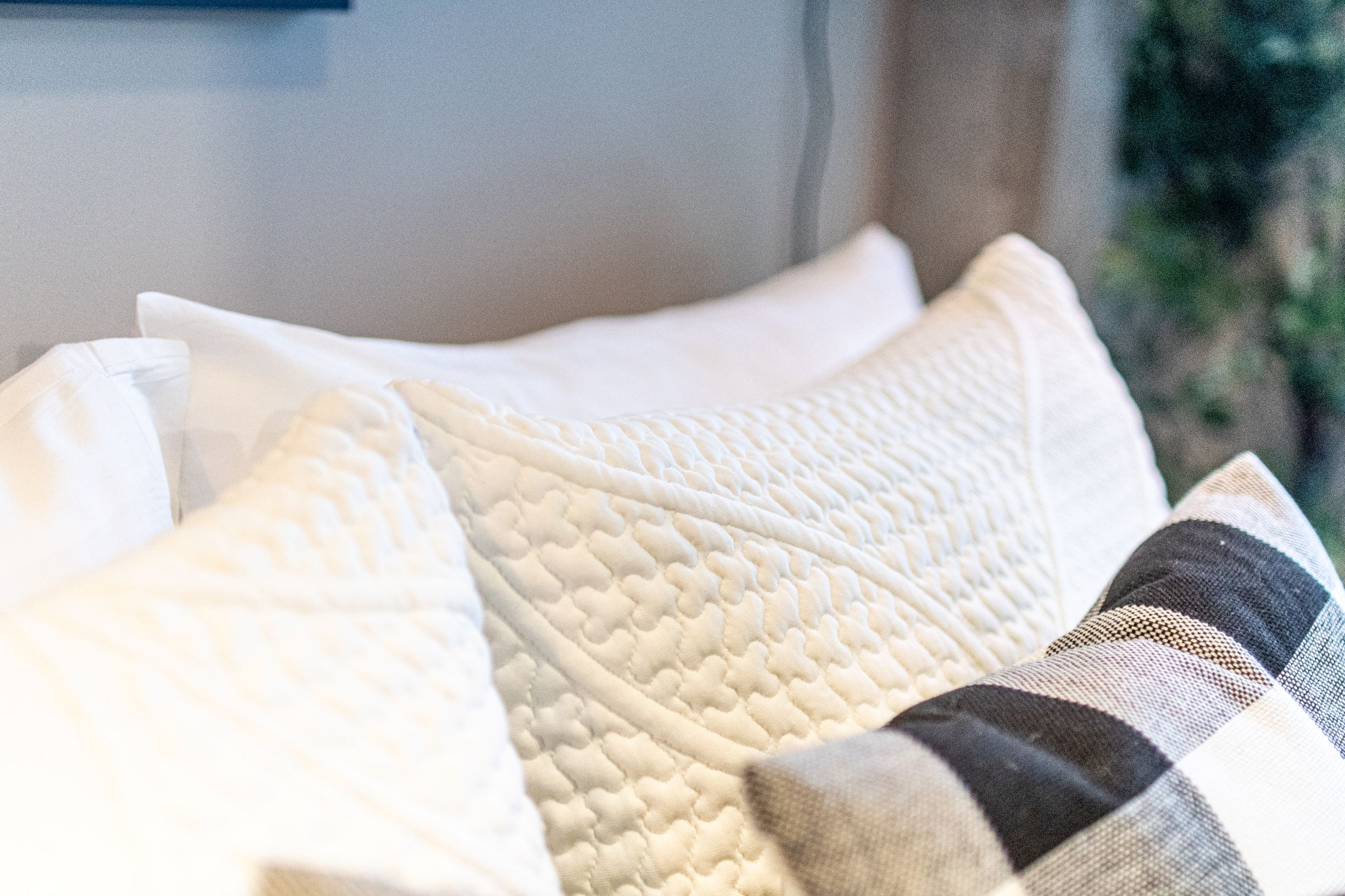 Close-up of decorative pillows with textured designs on a sofa.