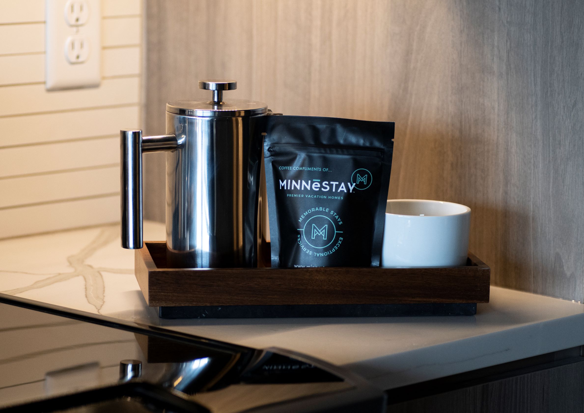 Cozy coffee setup featuring a French press and premium coffee at a vacation home.