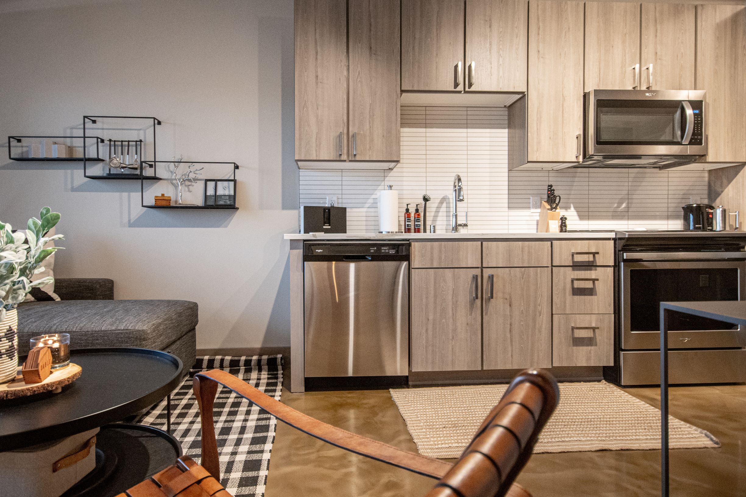 A modern kitchen and living area featuring sleek cabinetry and stylish decor.