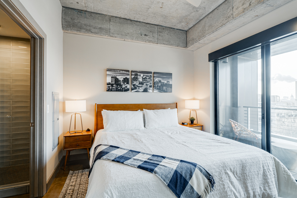 A modern bedroom featuring a cozy bed and urban decor.