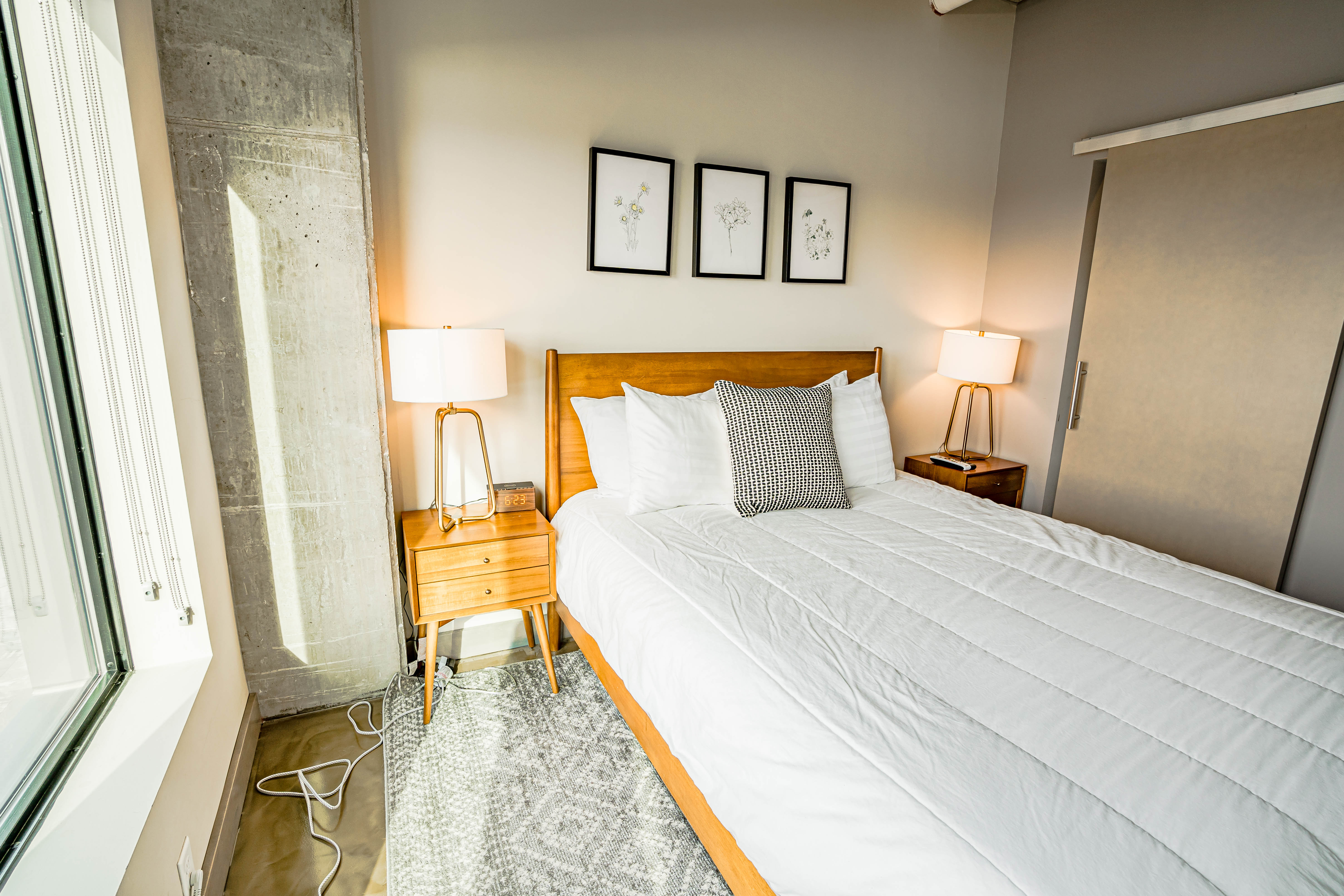A serene and modern bedroom featuring a comfortable bed and stylish decor.