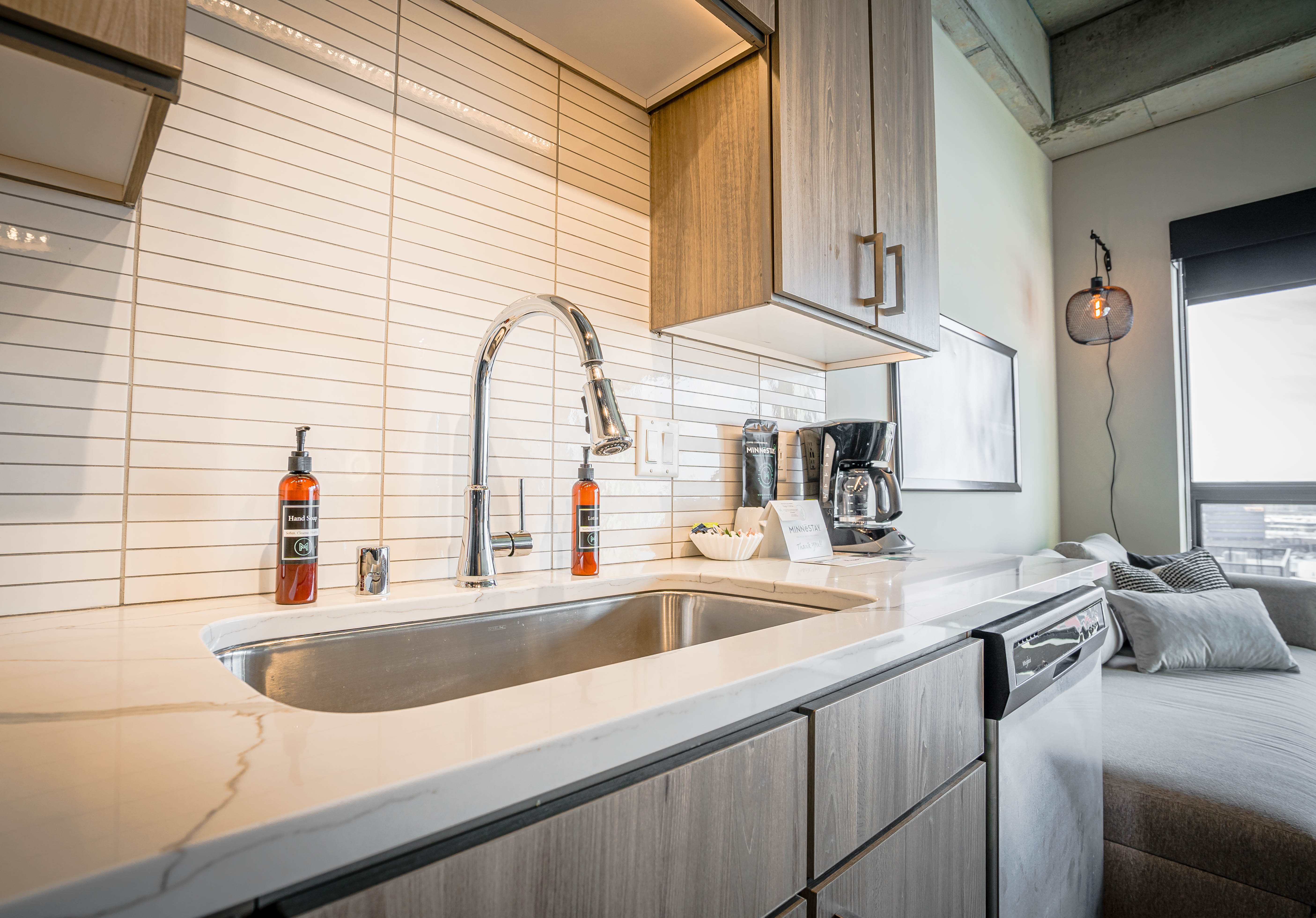 A modern kitchen featuring a sleek design with marble countertops and stylish appliances.
