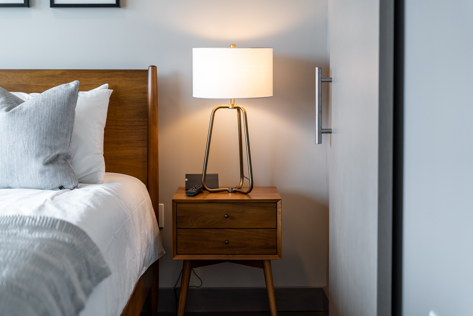 A serene bedroom with modern furnishings and warm lighting.