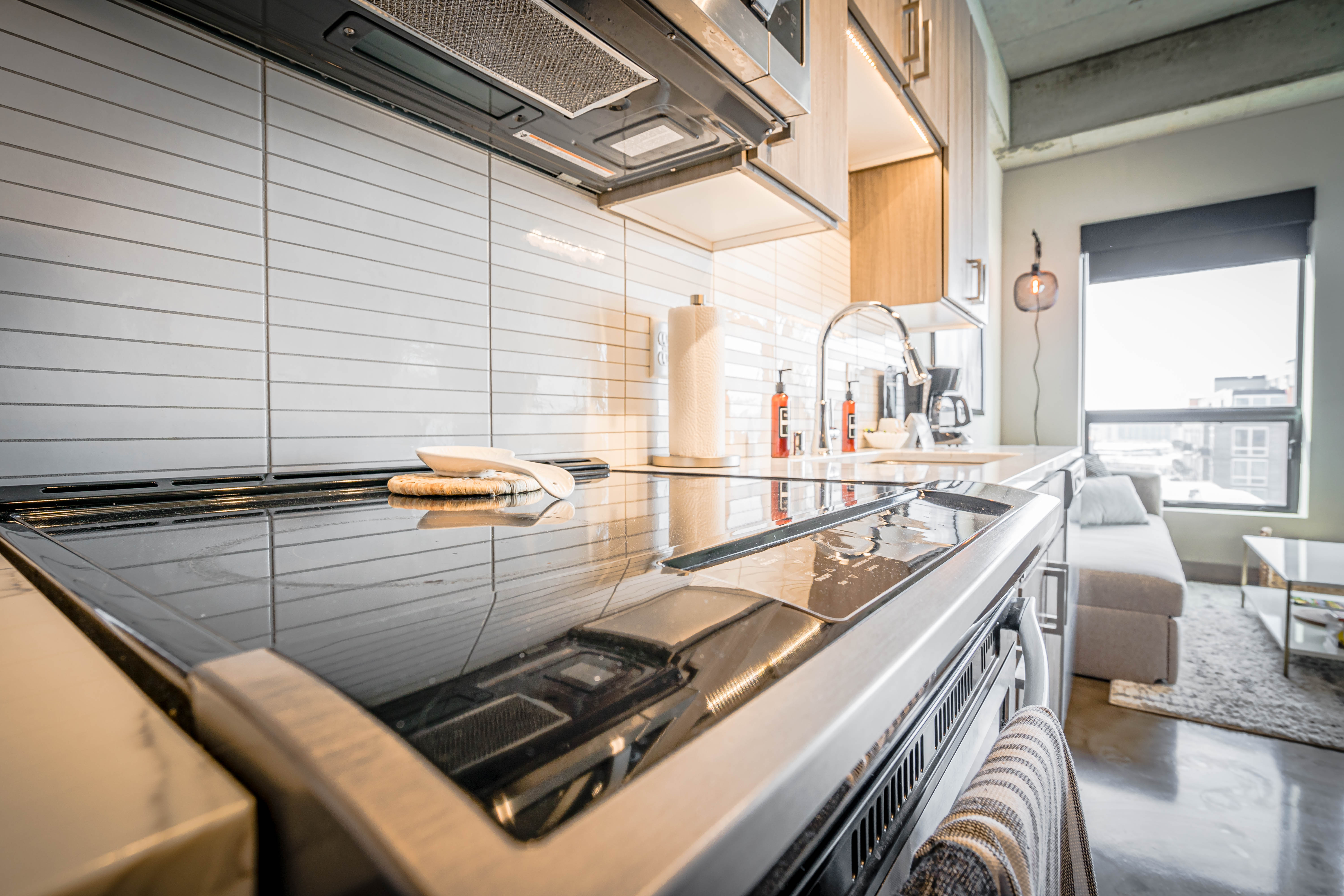A modern kitchen with sleek surfaces and minimalist design features.