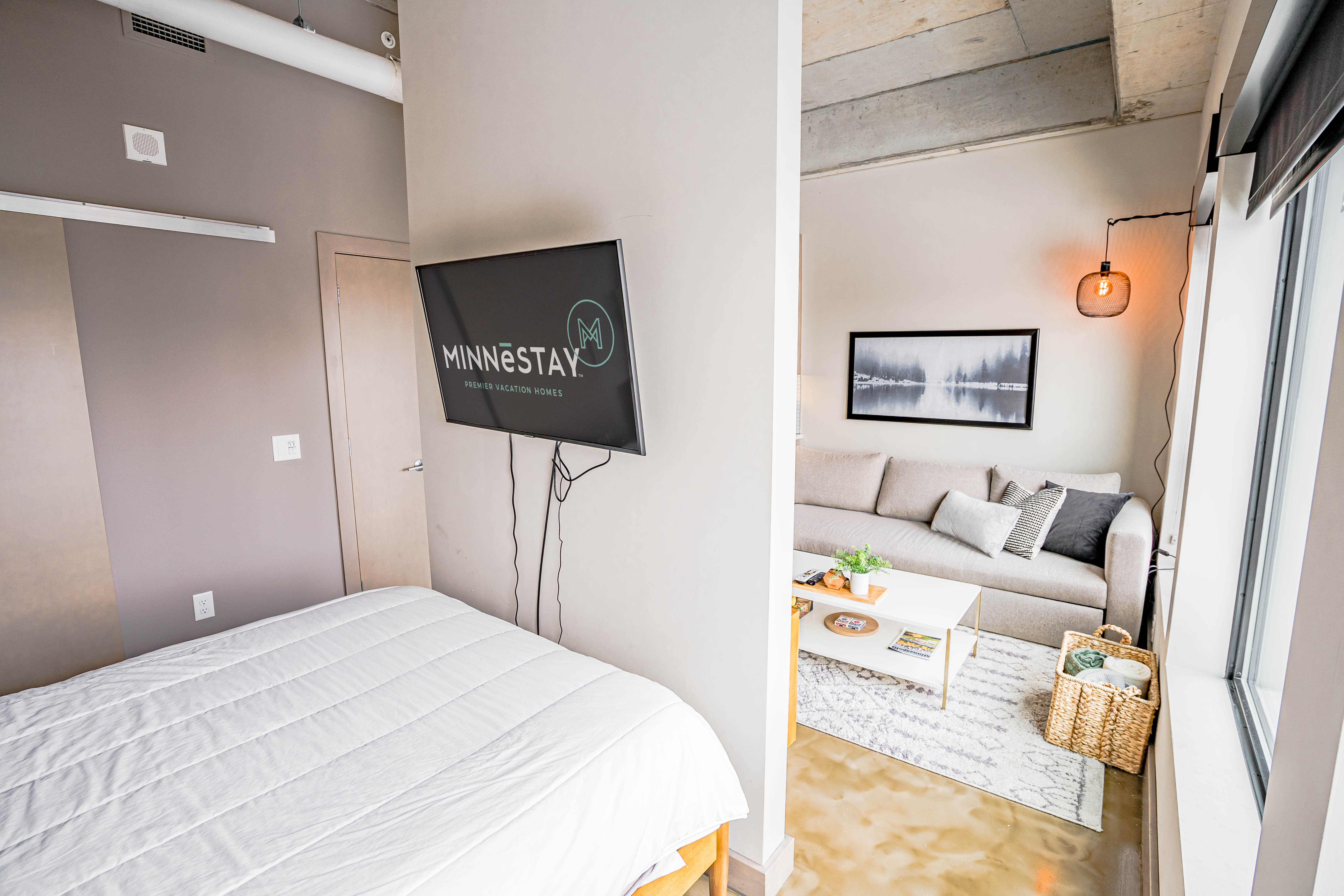 A stylish vacation rental featuring a cozy bed and modern living room.