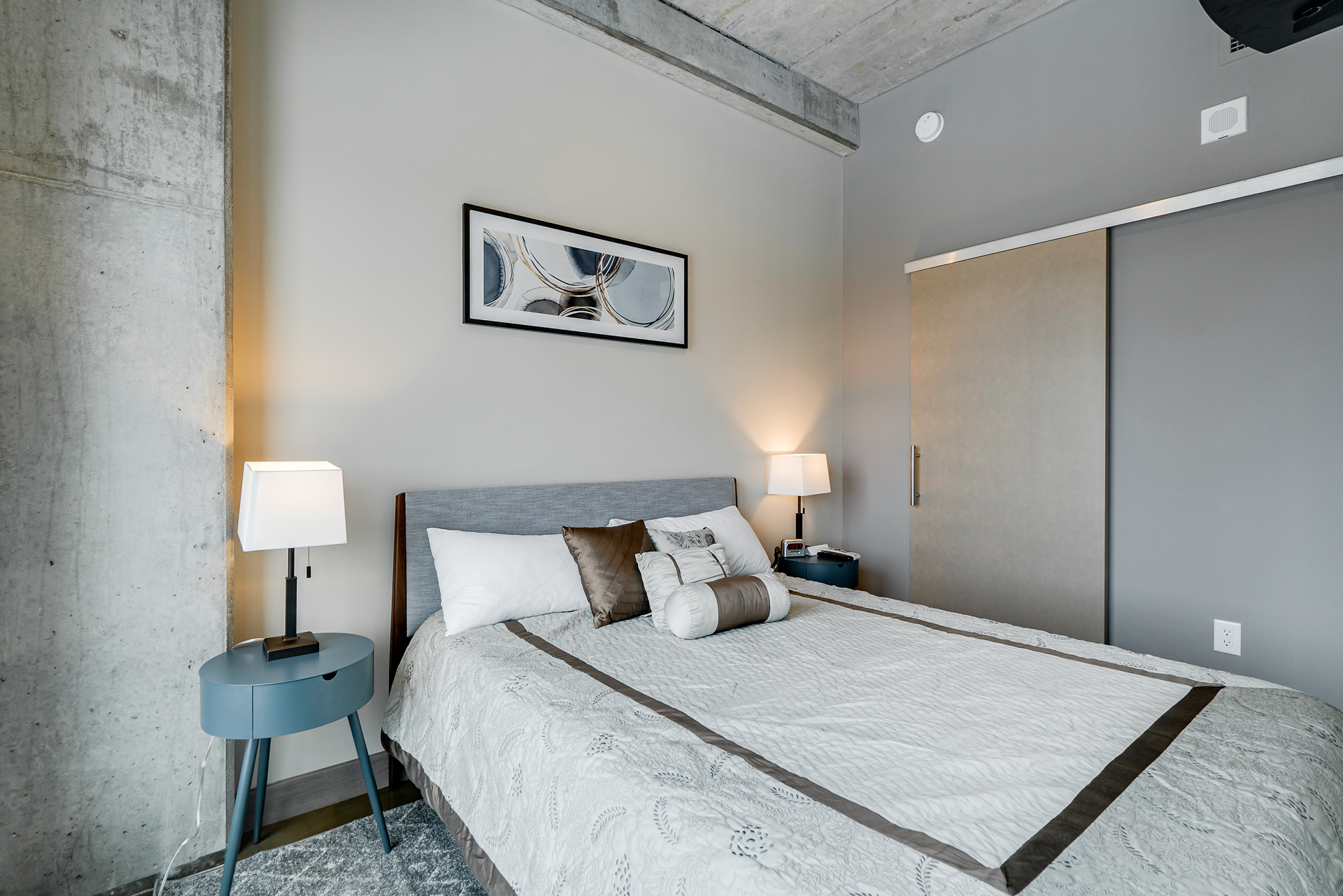 A stylish and cozy bedroom with modern decor and industrial accents.