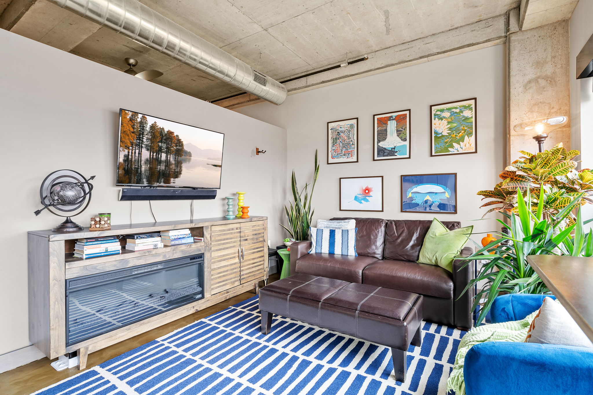 A modern living room with industrial elements and vibrant art.