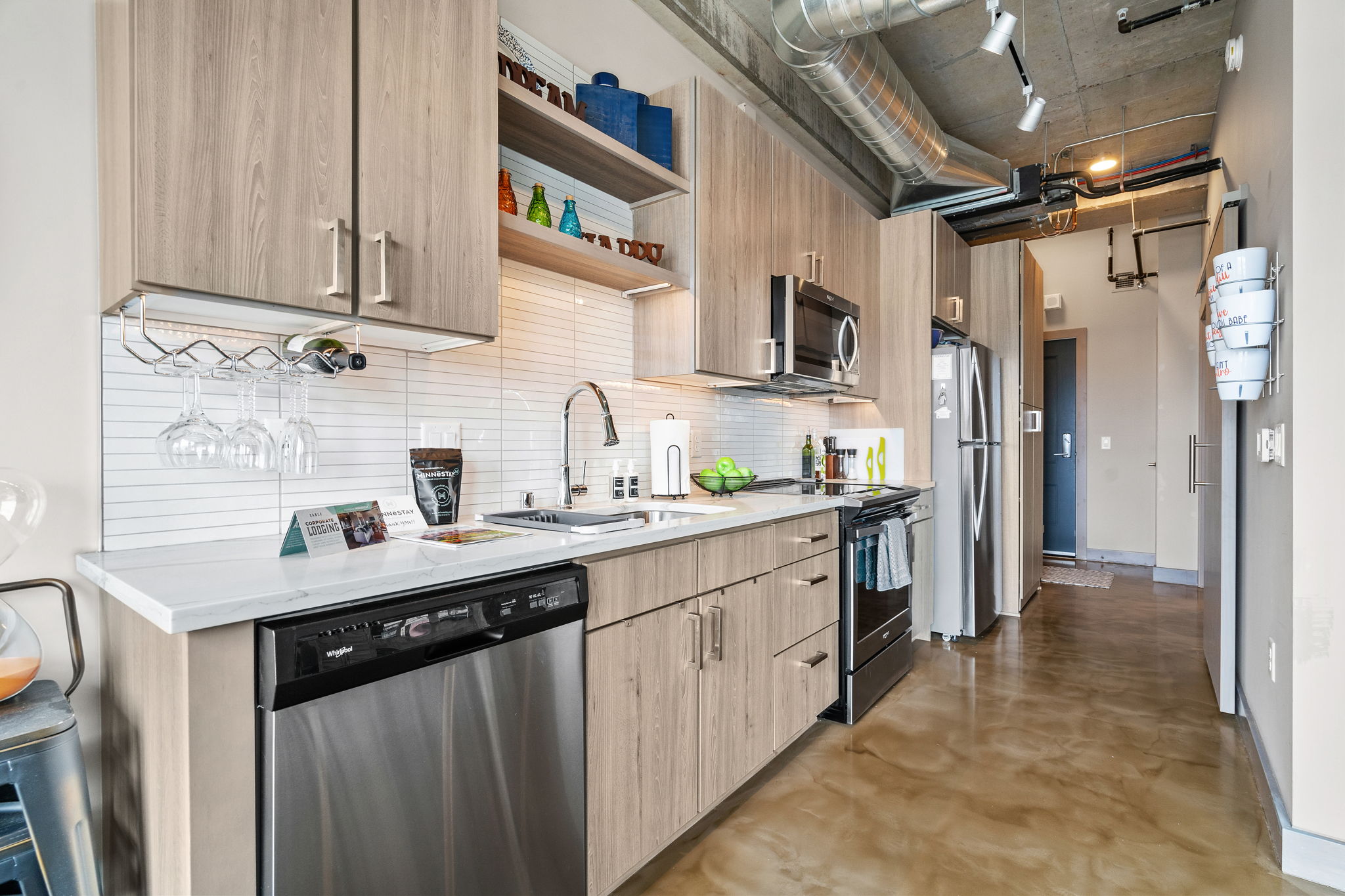 A stylish and modern kitchen featuring light wood cabinetry and vibrant decor.