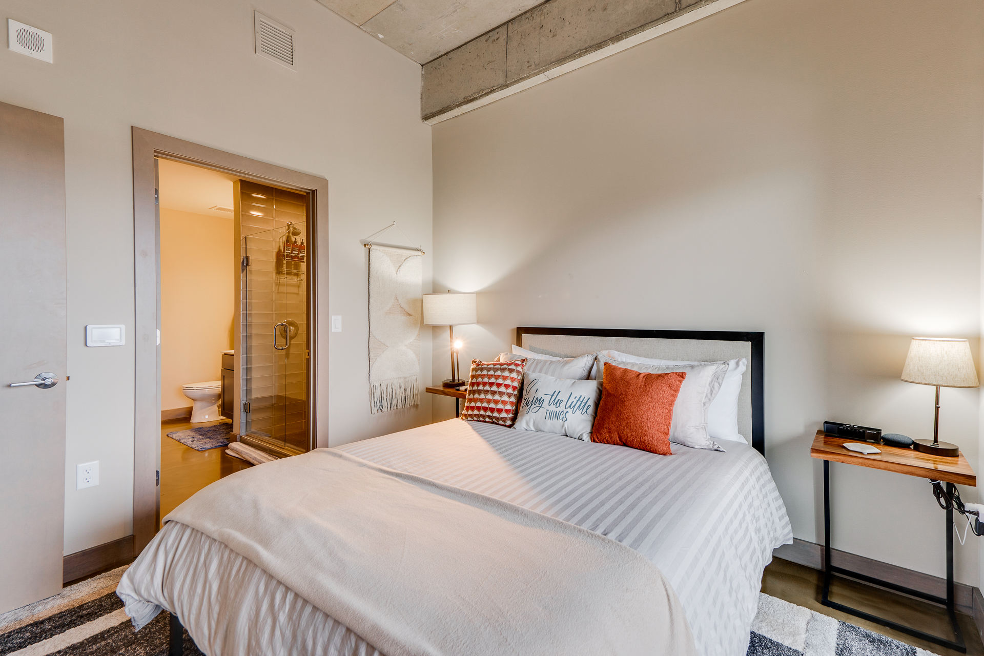 A modern bedroom featuring cozy bedding and a chic decor style.