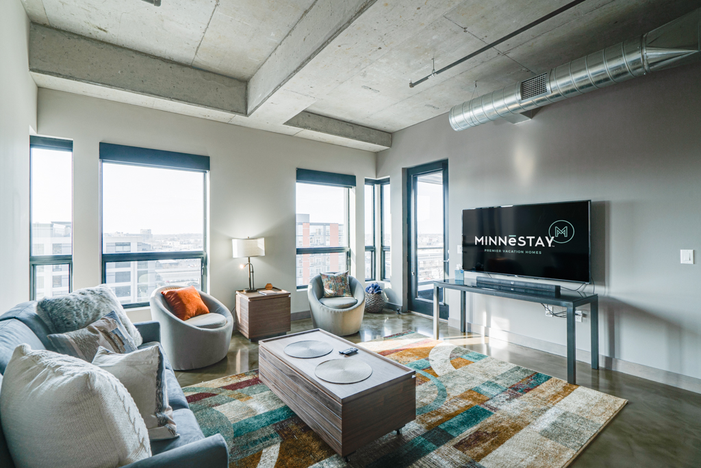 Stylish modern living room with city views and vibrant decor.