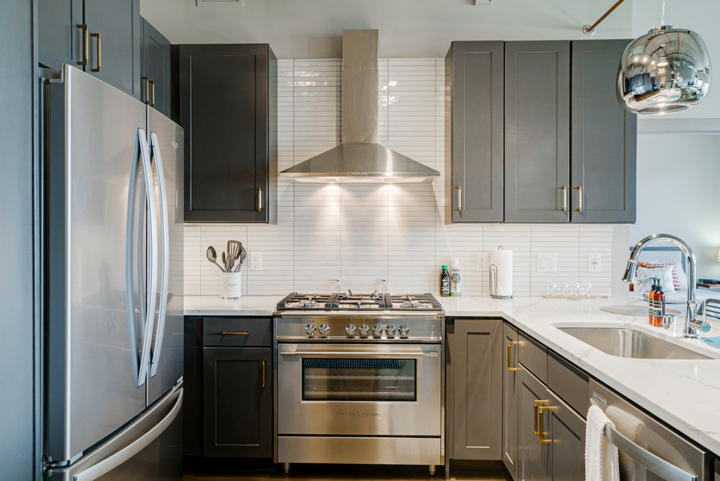 A modern kitchen featuring sleek design and stainless steel appliances.