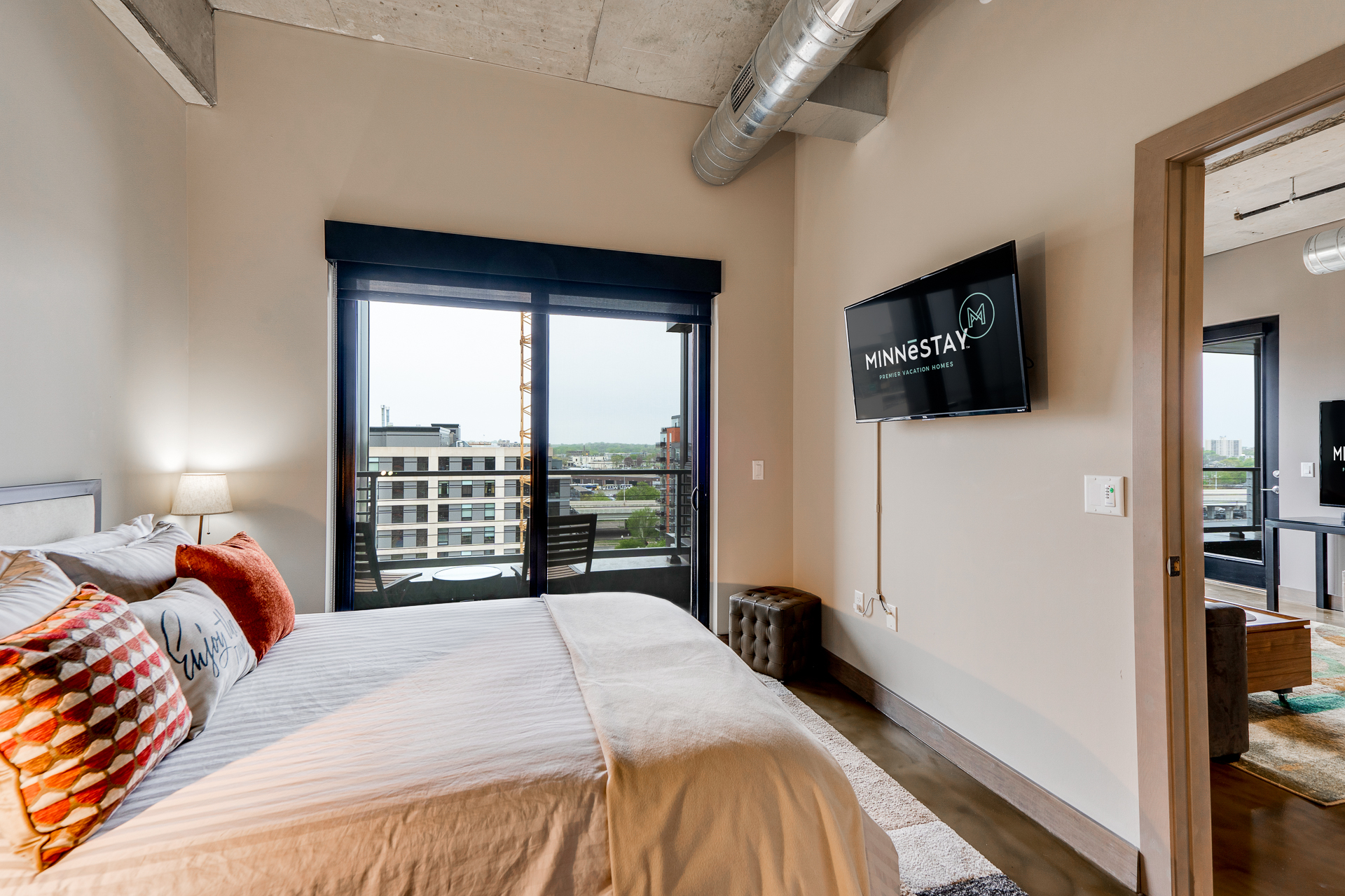 Modern bedroom suite with urban views and stylish decor.