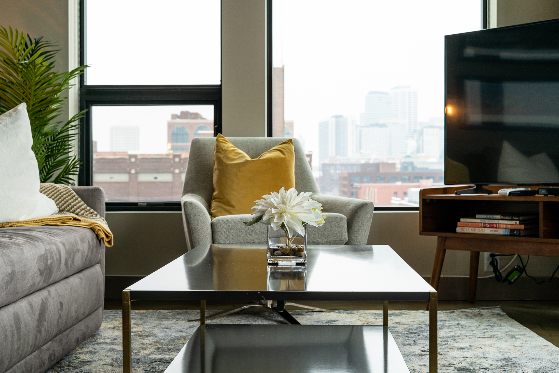A stylish living room with modern furnishings and a city view.