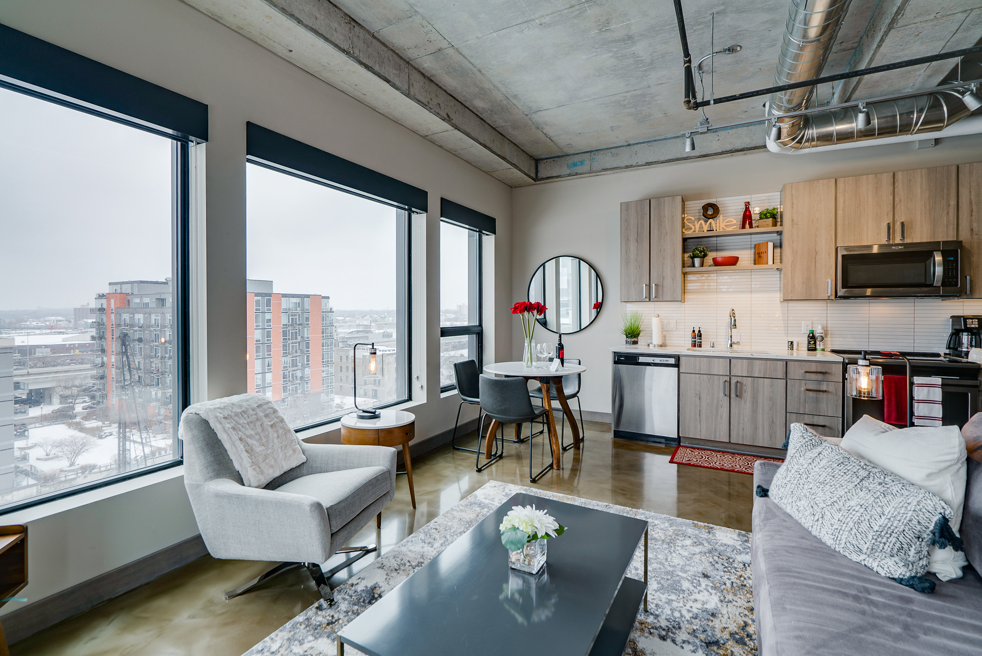 A stylish modern apartment with urban views and contemporary furnishings.