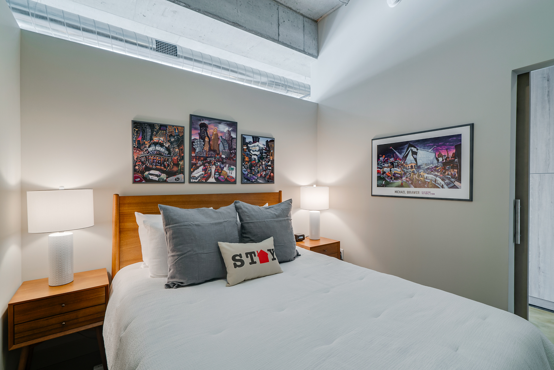 Cozy modern bedroom with artistic decor and inviting atmosphere.