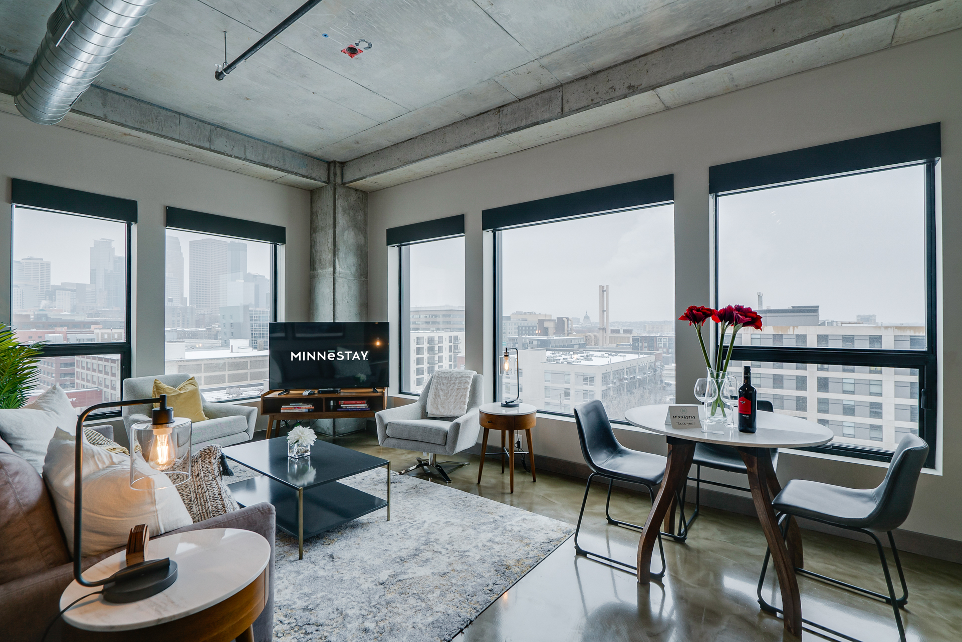 A chic and cozy modern living area with stunning city views.