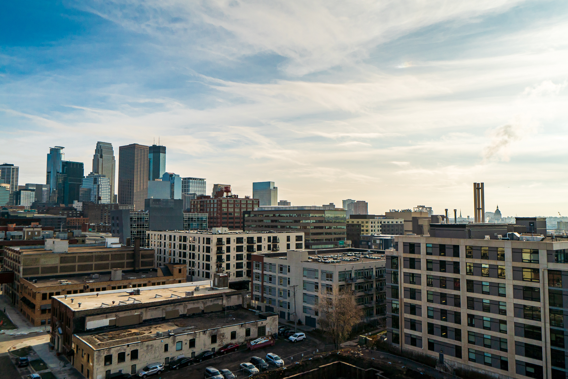 A stunning panoramic view of a vibrant urban skyline against a clear sky.