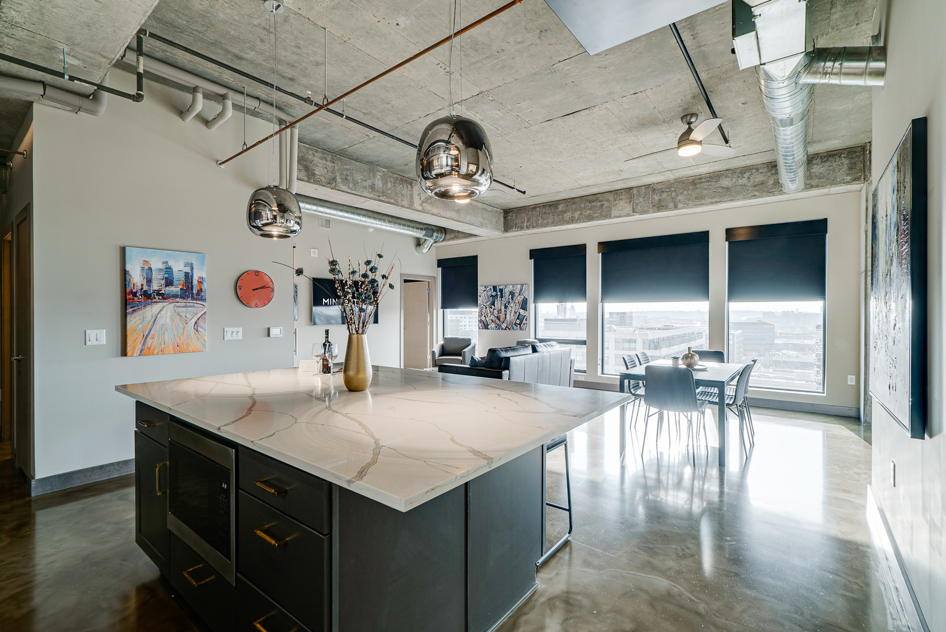 A modern apartment featuring a stylish kitchen and open living area with city views.