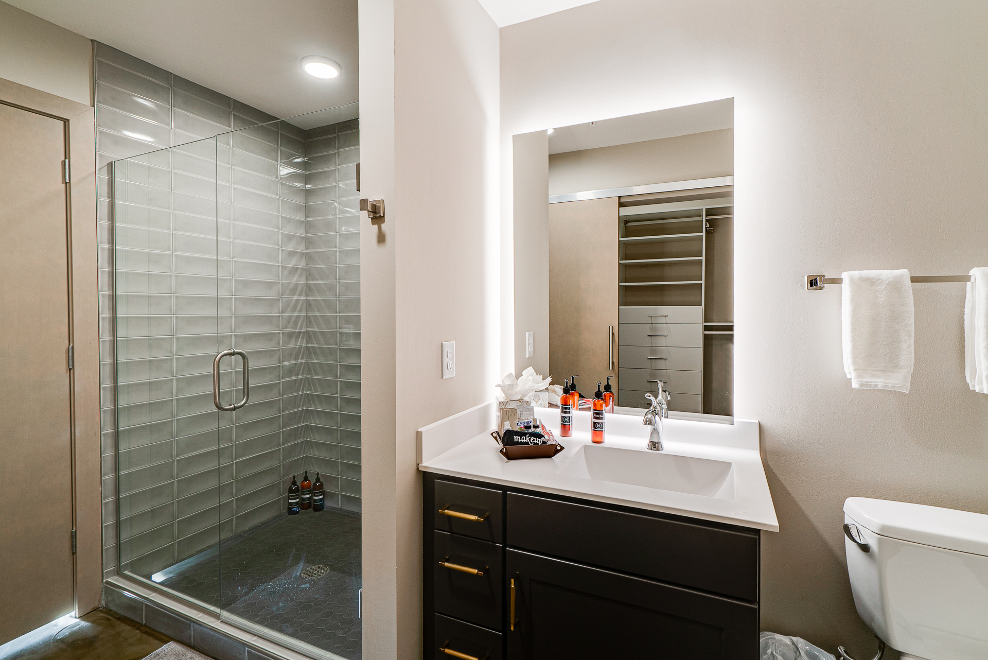 A modern and sleek bathroom showcasing a glass shower and elegant vanity.