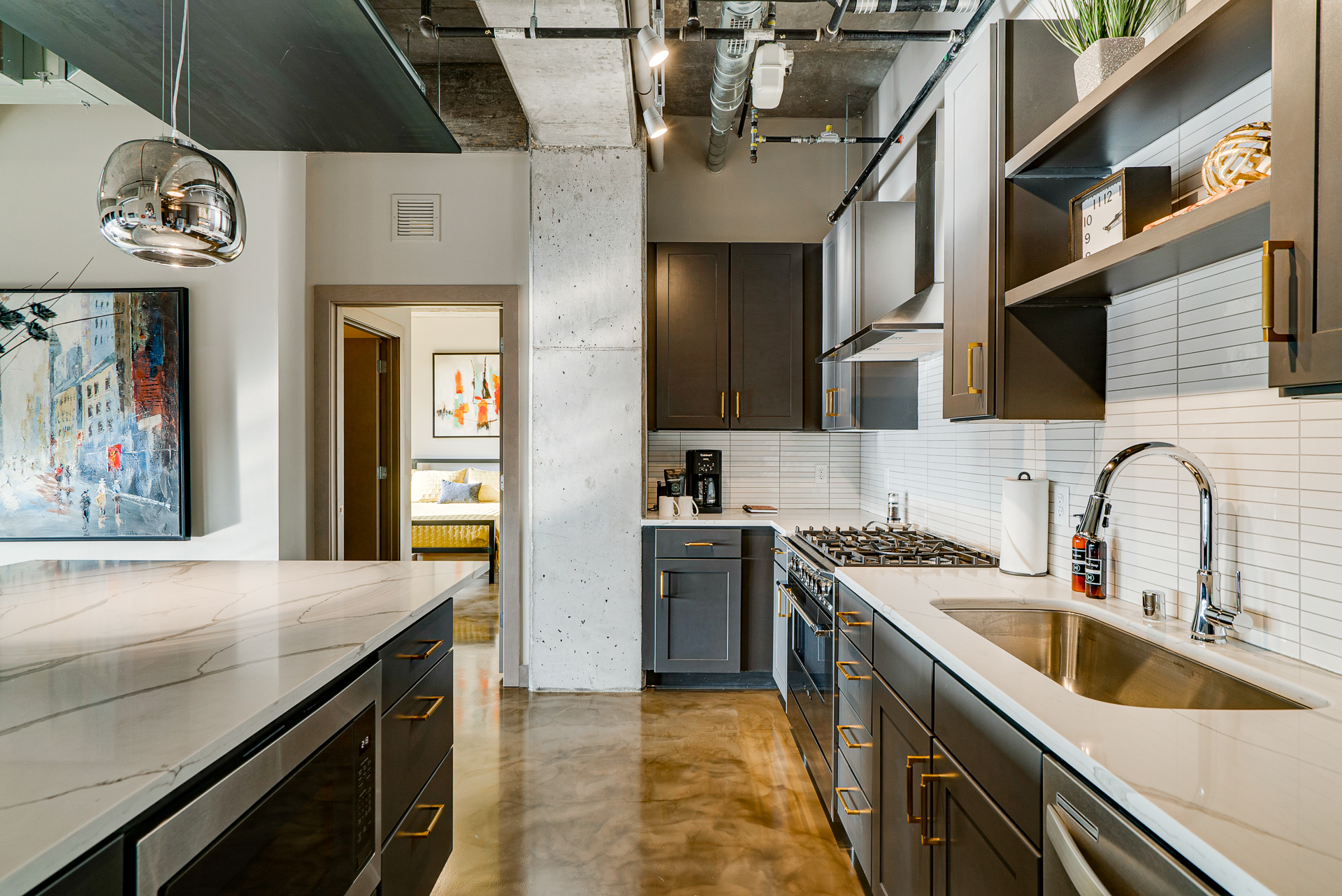 Chic modern kitchen with dark cabinets and polished island.