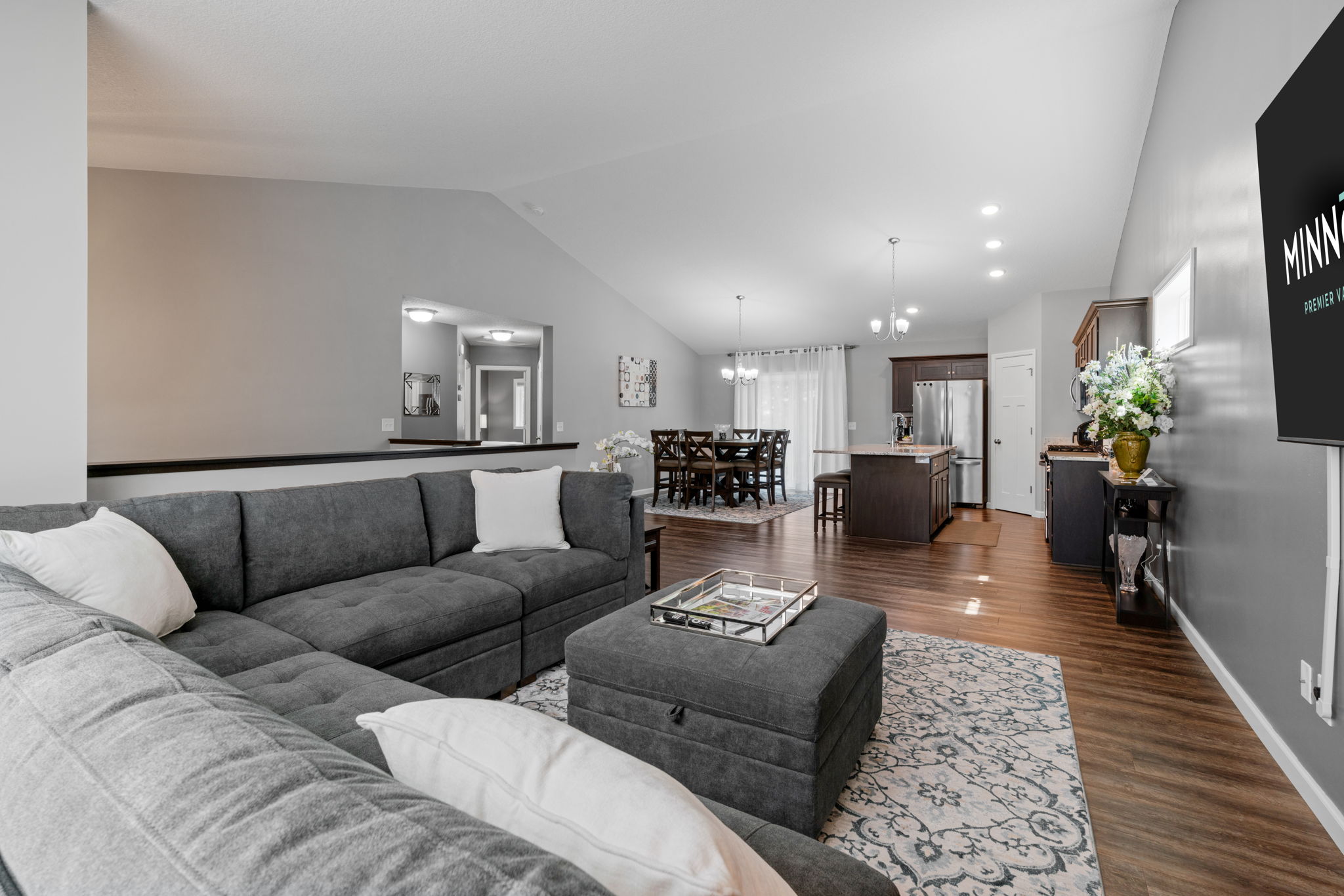 Spacious modern living room featuring a cozy sectional sofa and dining area.