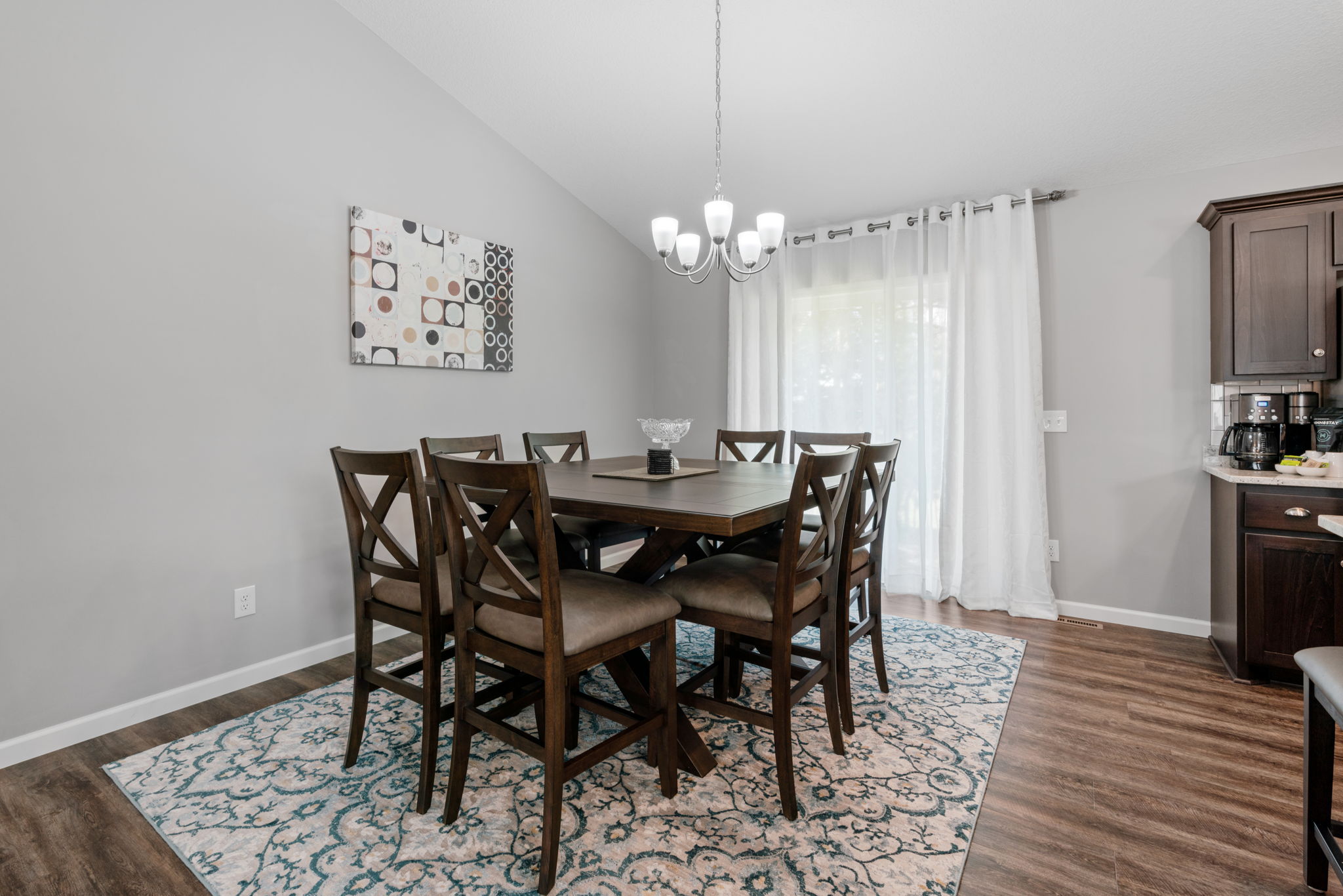 Elegant dining area featuring a wooden dining set and stylish decor.