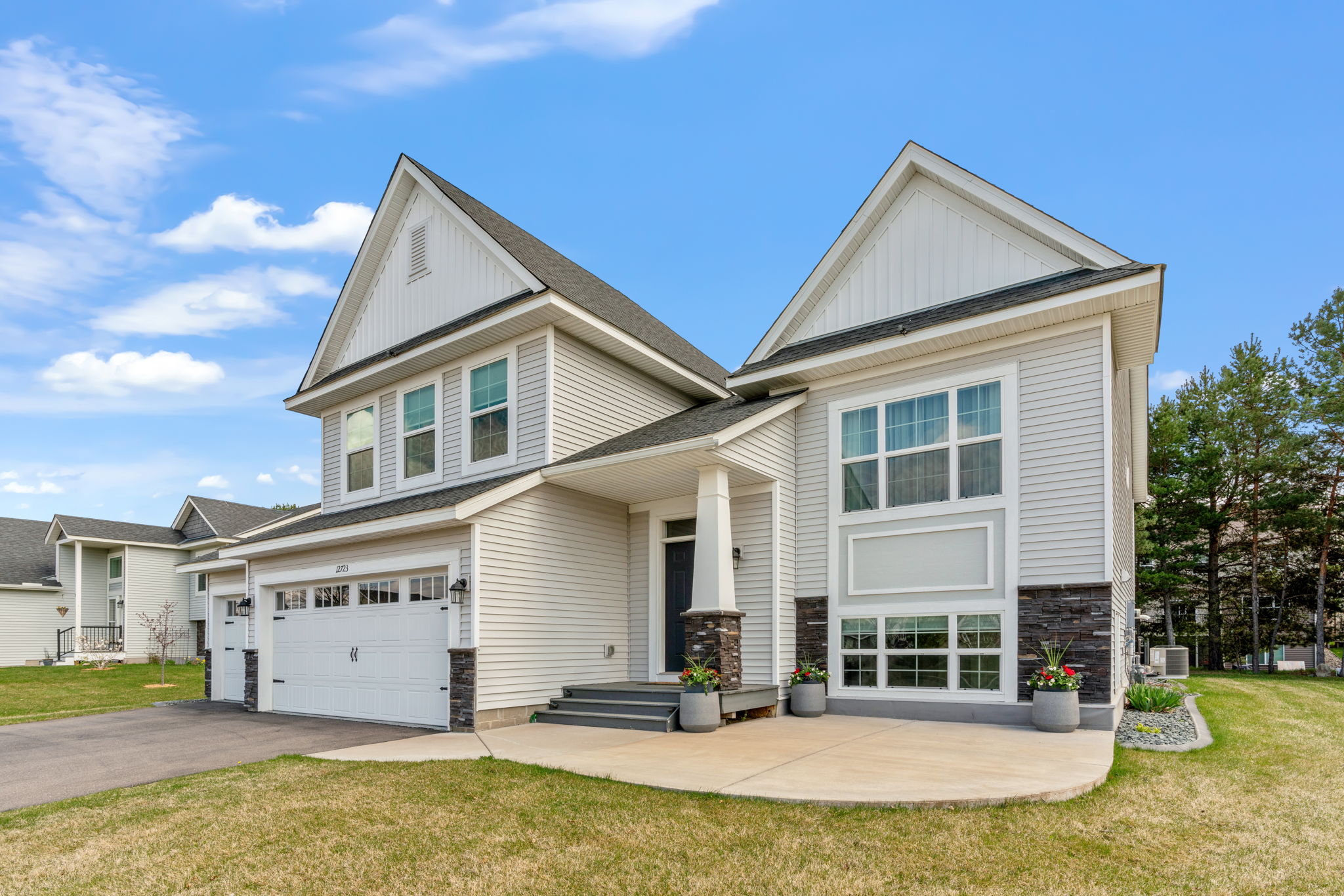 A modern two-story house with a stylish facade and a welcoming entrance.