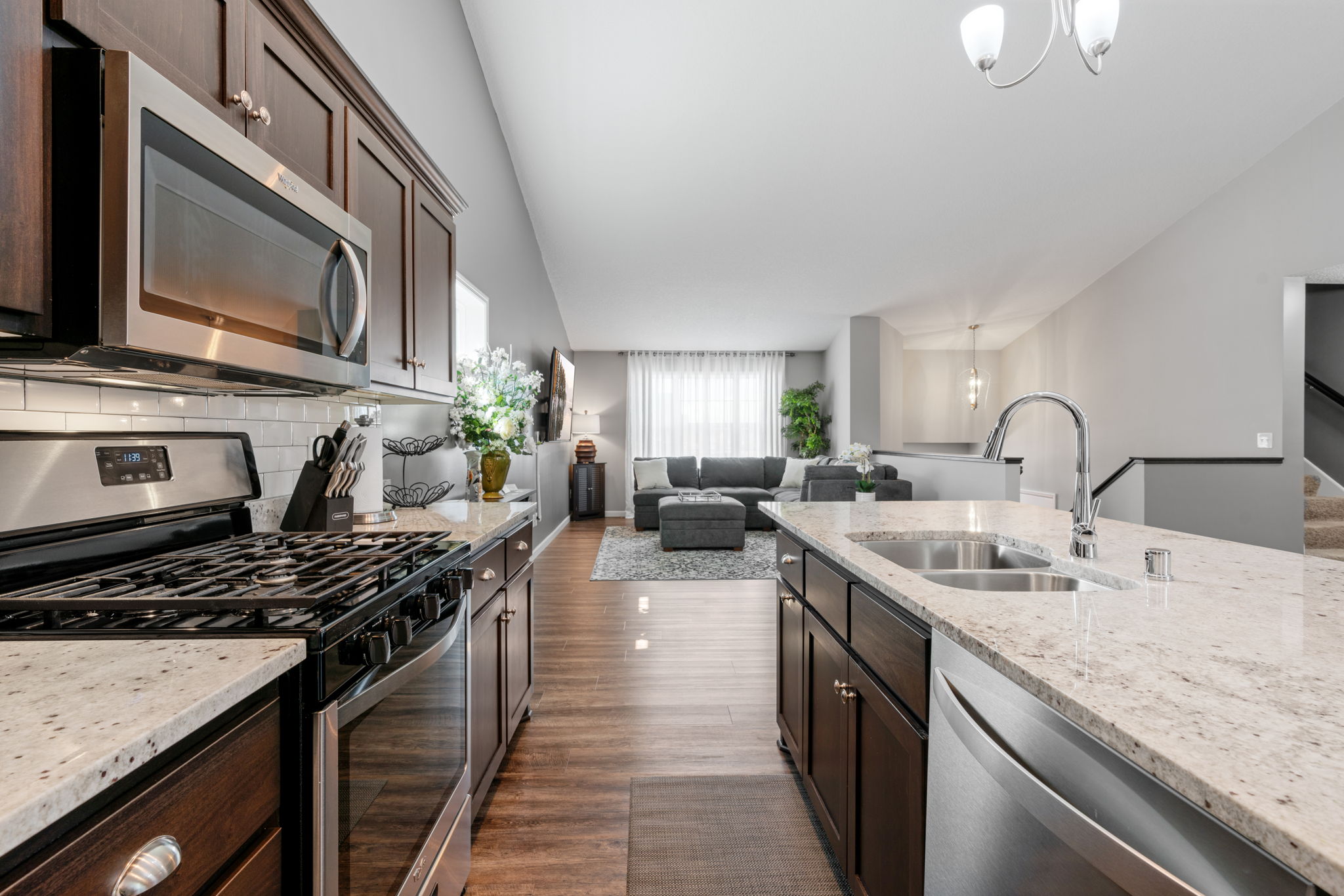 A contemporary kitchen opens into a cozy living area, featuring modern finishes and natural light.