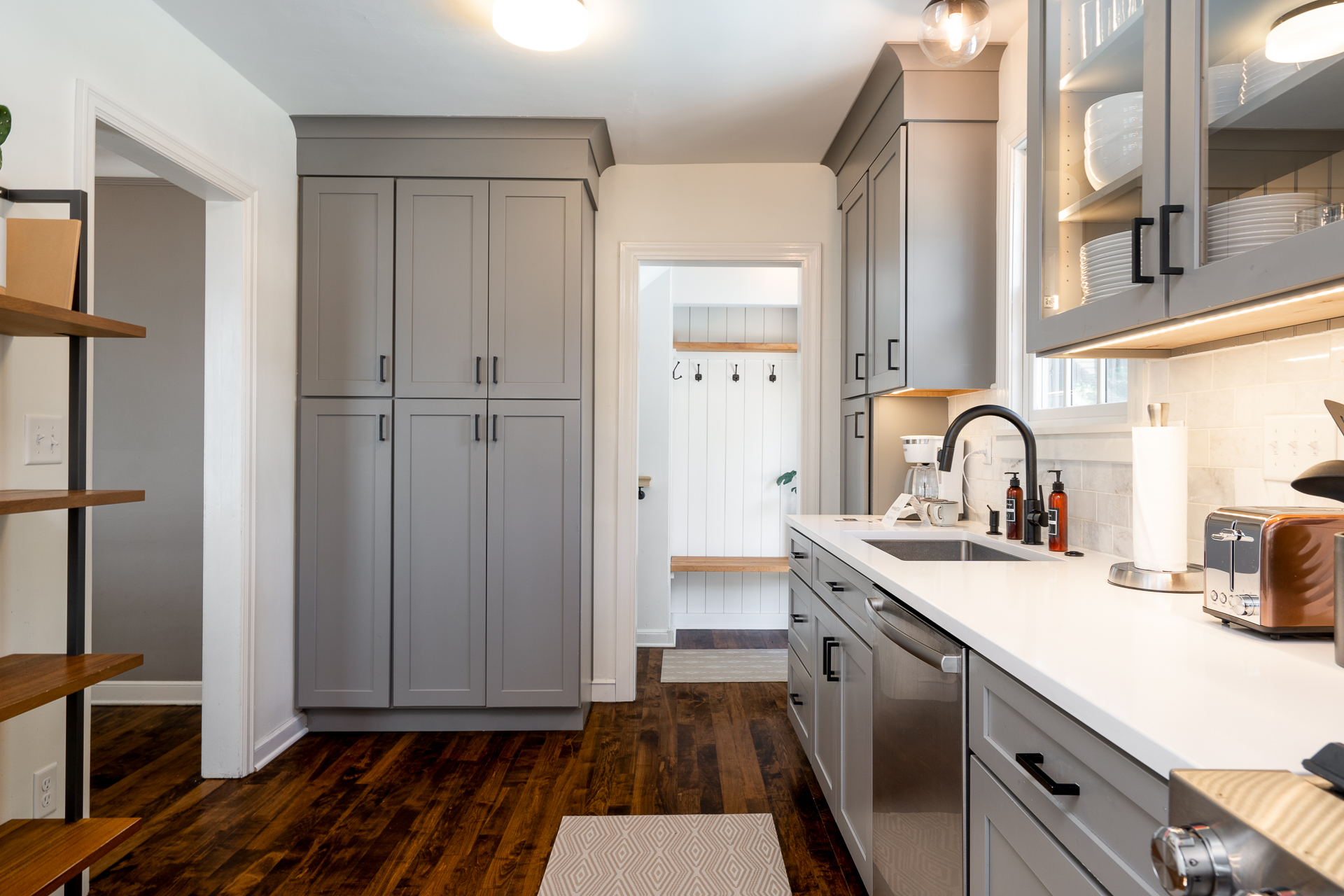 A modern kitchen with gray cabinets and stylish accents.
