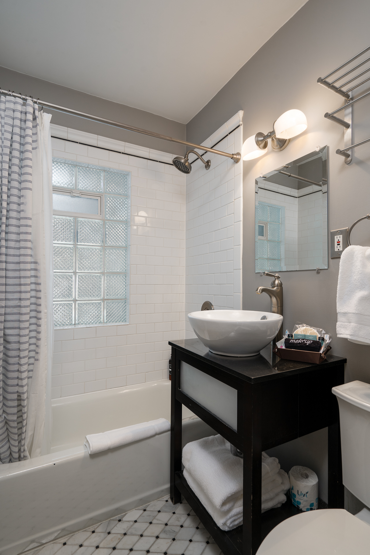 A sleek and modern bathroom with elegant fixtures and minimalist design.