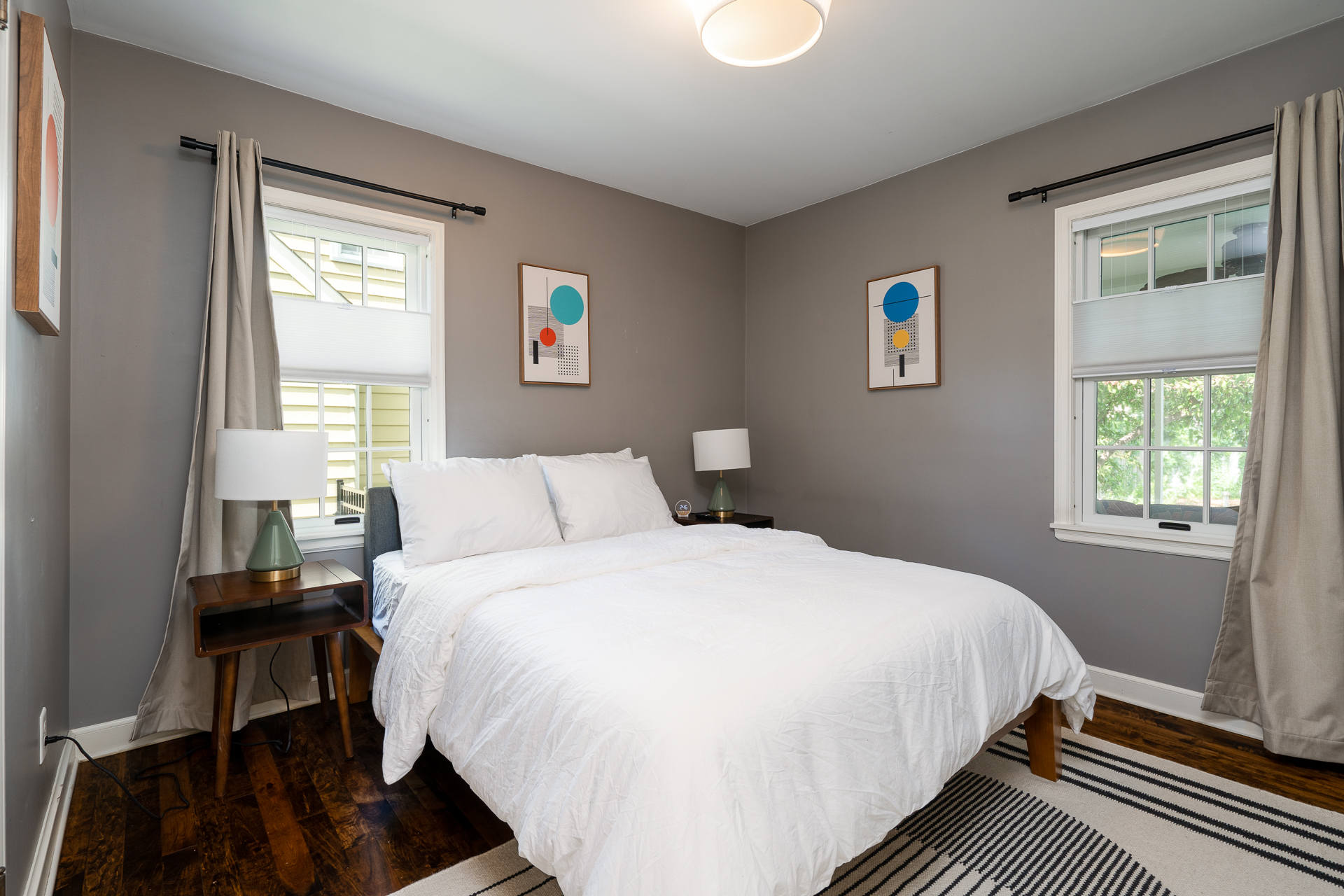 A modern bedroom with cozy decor and bright accents.