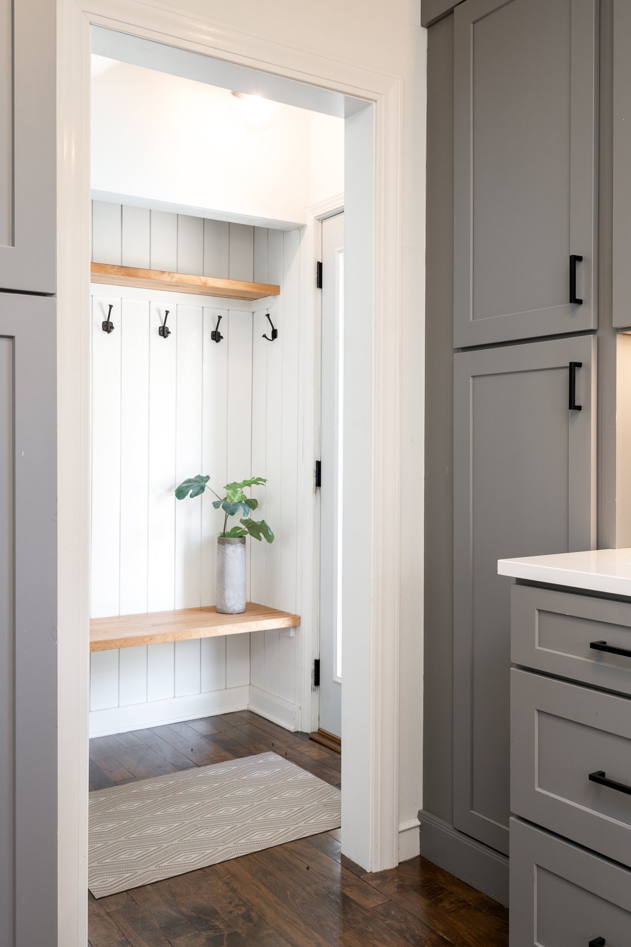 A stylish mudroom with functional seating and decor.
