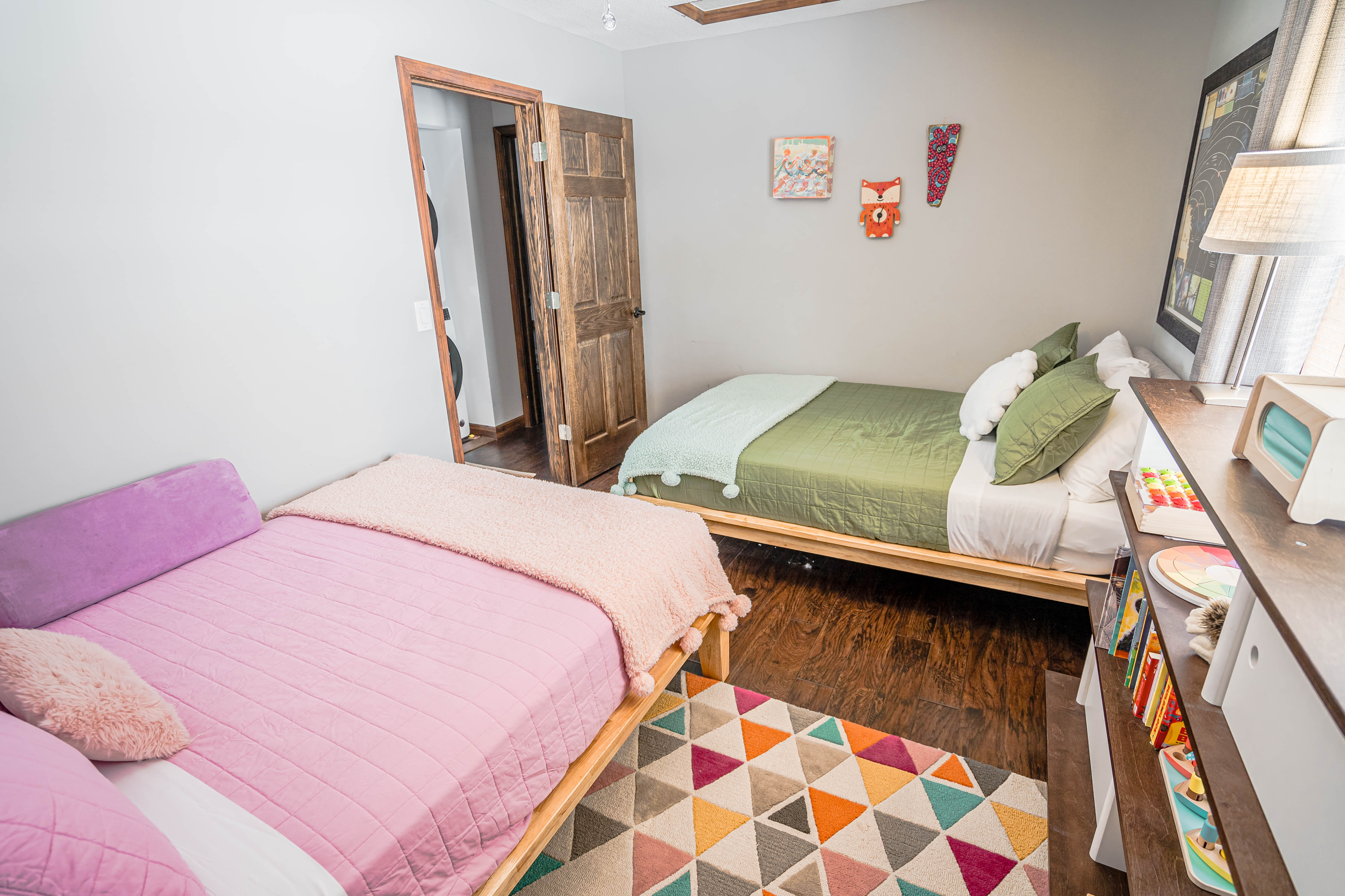 A cozy children's bedroom with colorful beds and playful decor.