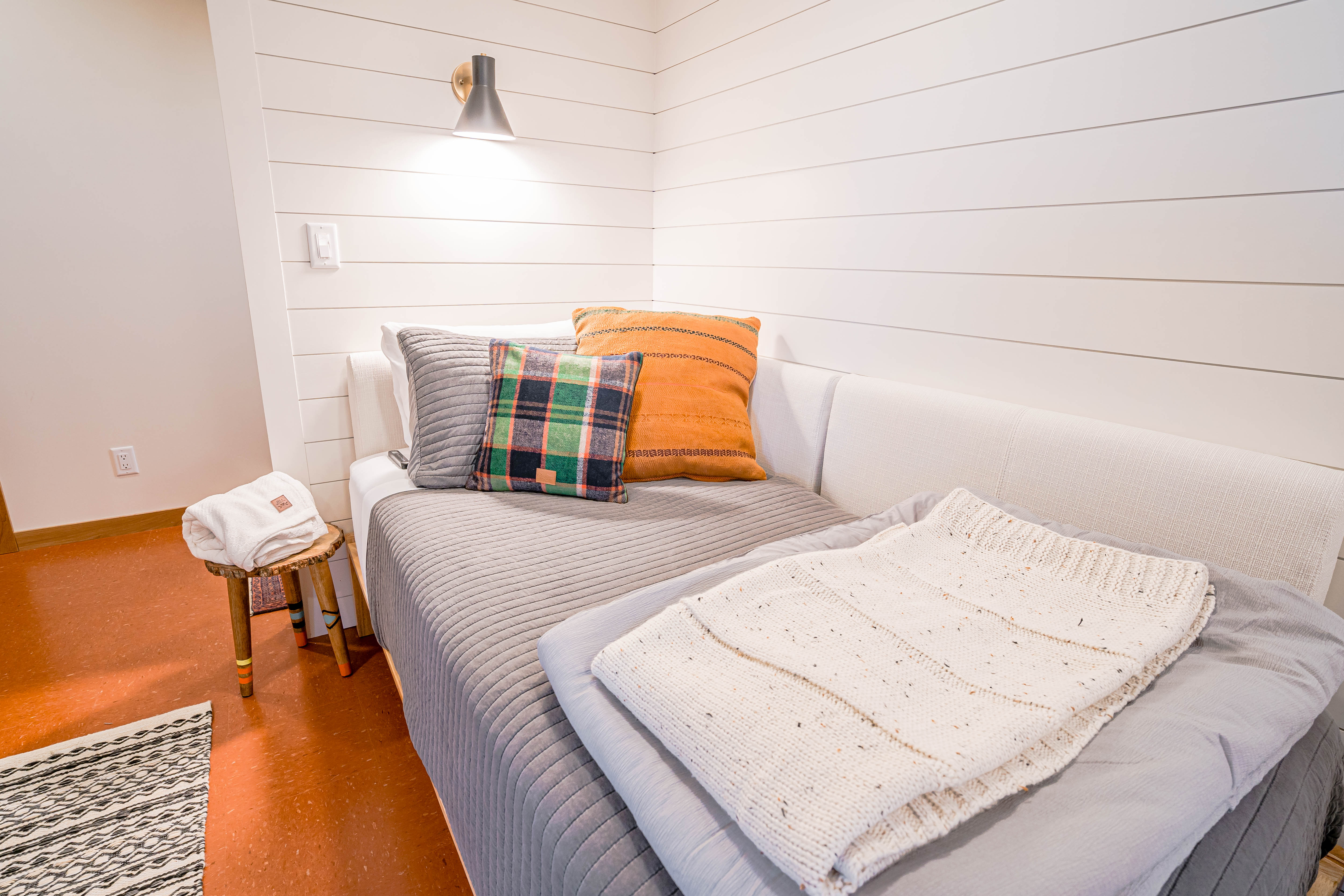 Cozy corner of a room with a stylish couch and decorative cushions.
